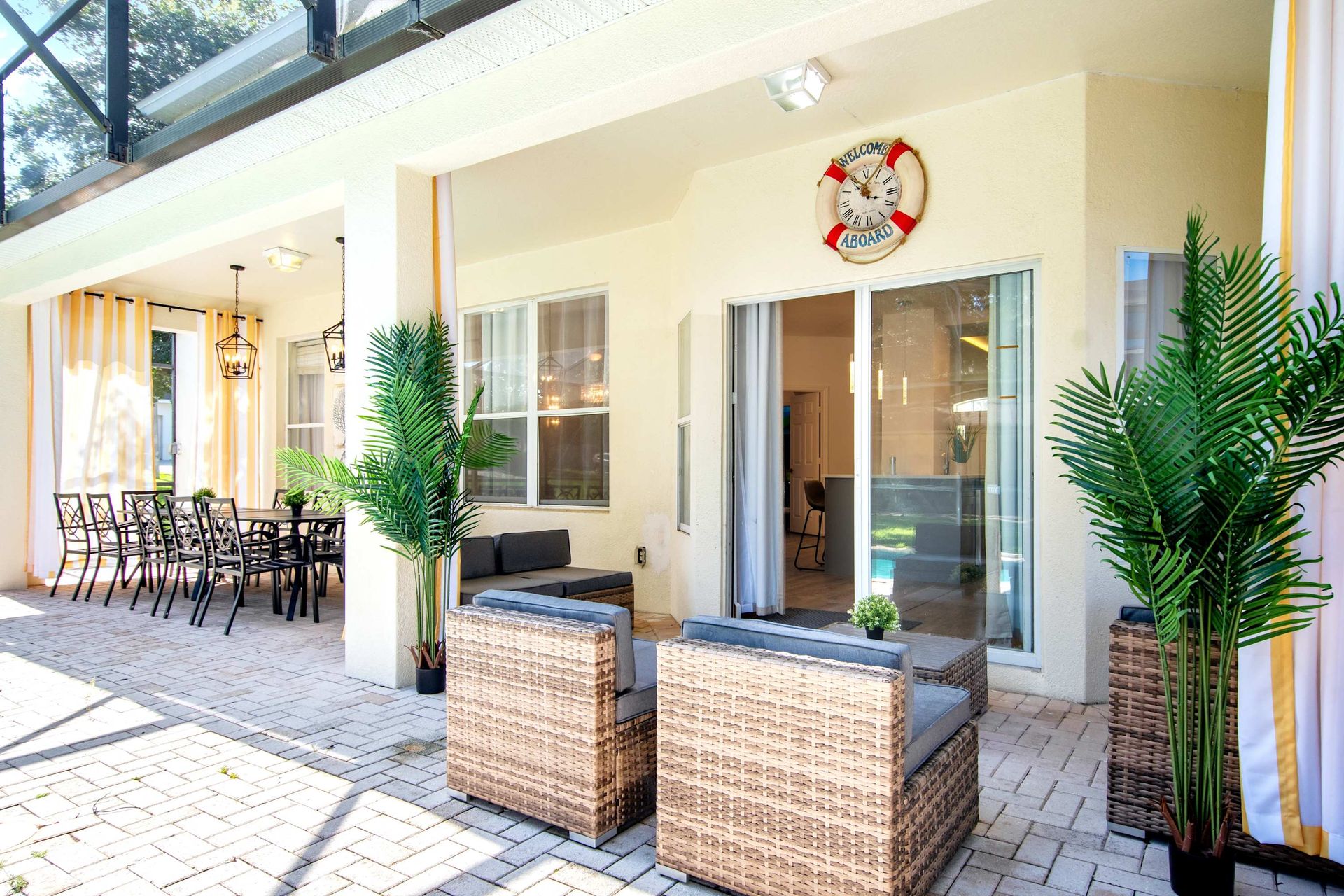 Tropical vibes: nautical decor and wicker furniture on a sunny patio.