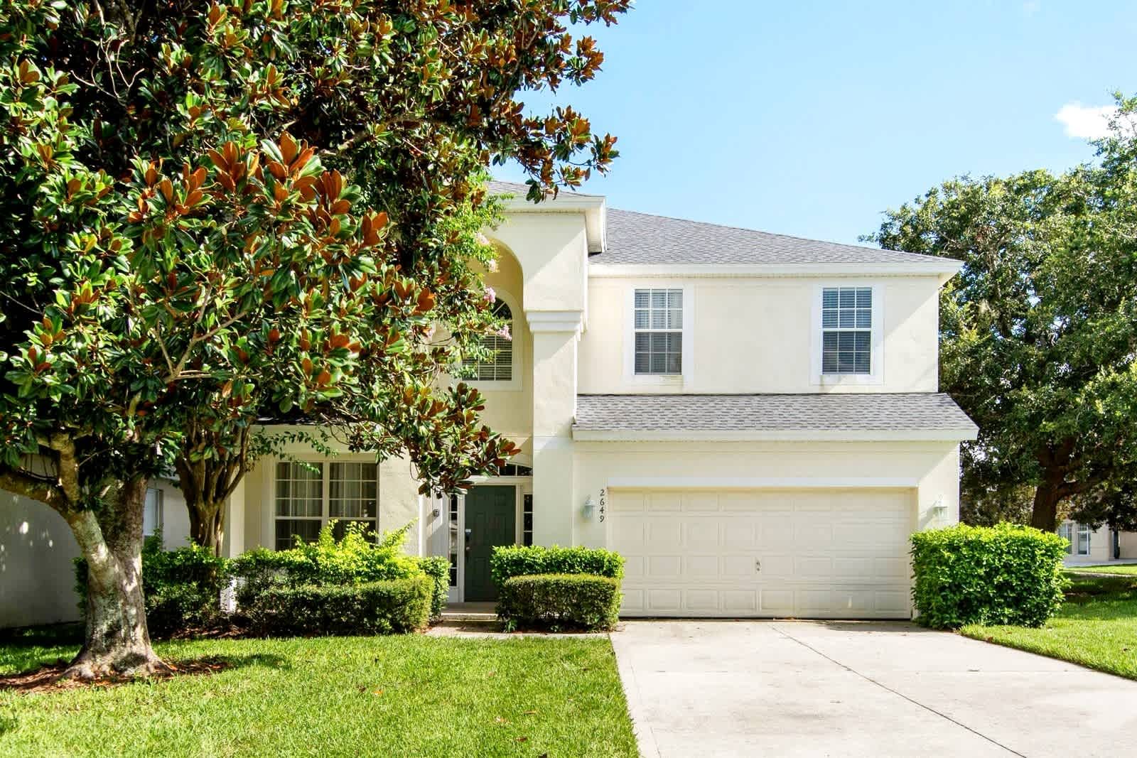 Classic two-story vacation home with a spacious lawn. 