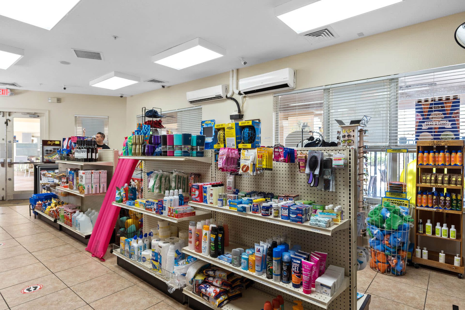 Convenience store stocked with toiletries, snacks, and vacation supplies.