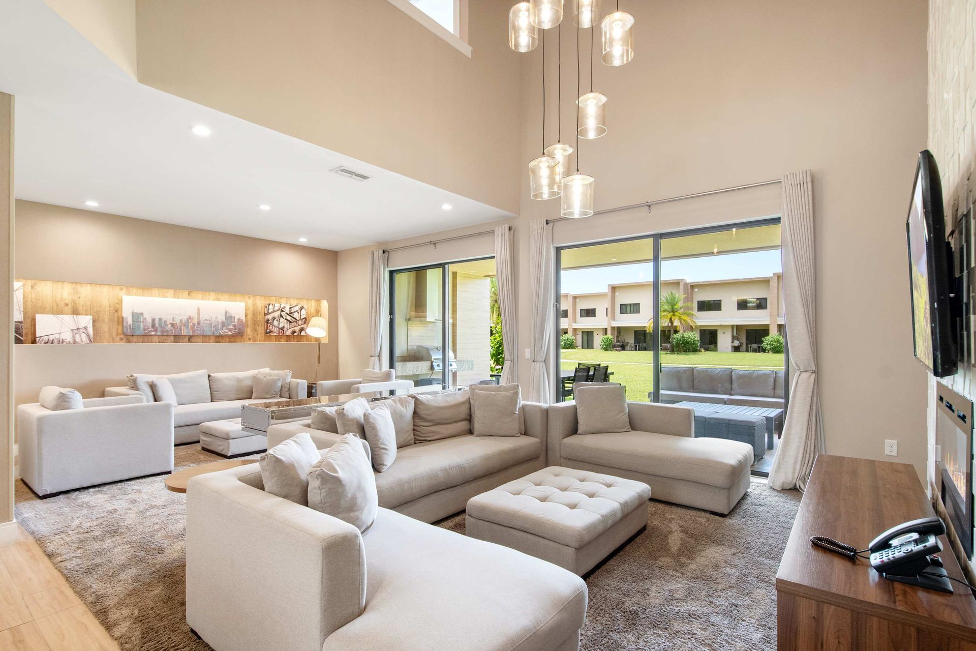 Vast, open-concept lounge with high ceilings and plush sectional seating.