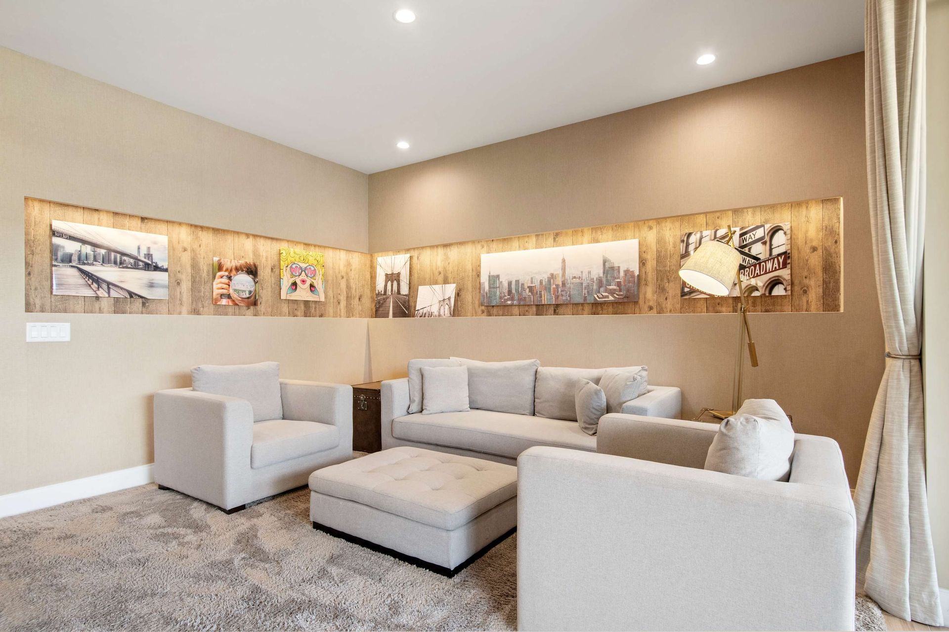 Stylish lounge with plush, neutral seating and a unique wood-paneled art niche.
