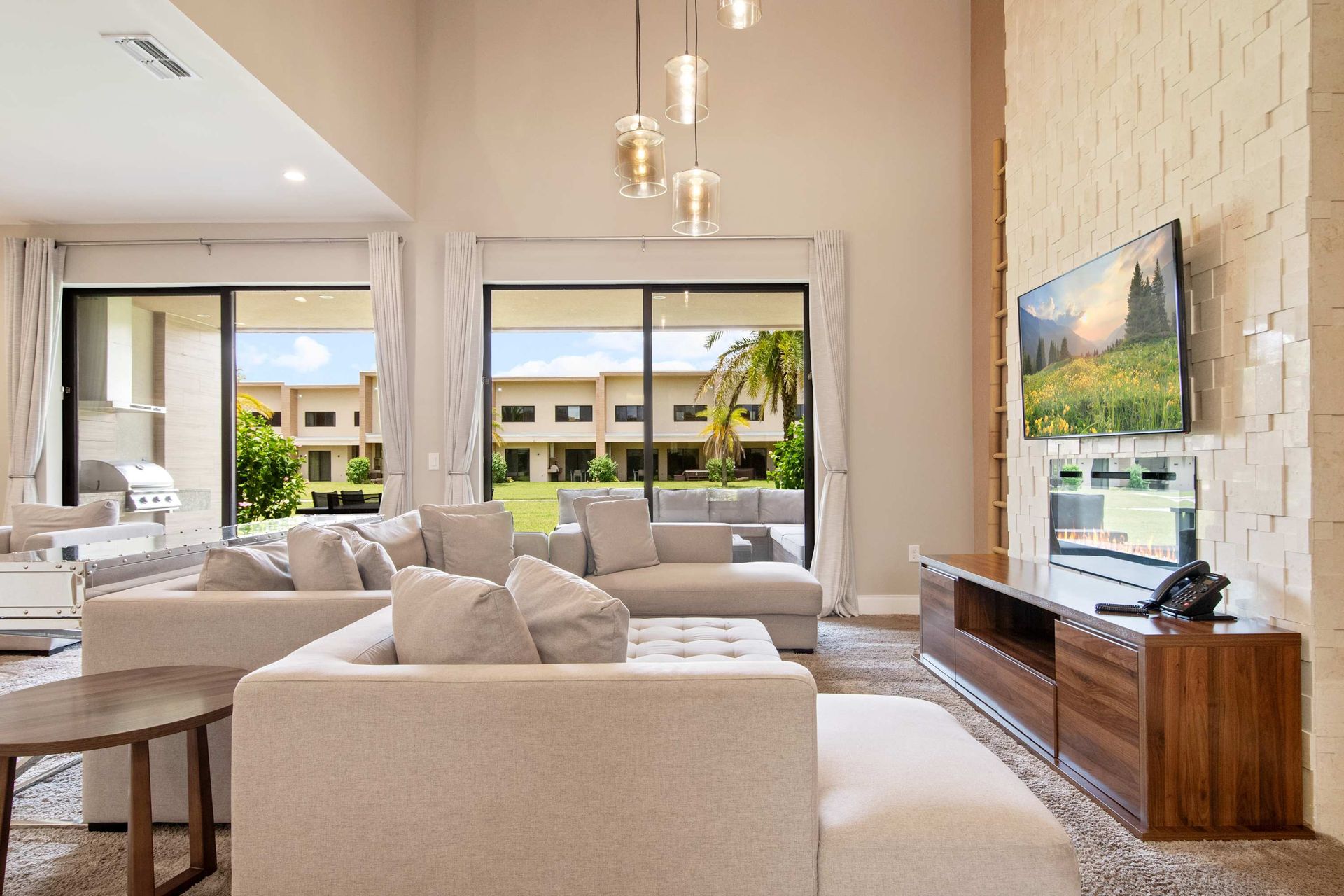 Two-story windows and chic stone wall define this bright, luxury lounge.