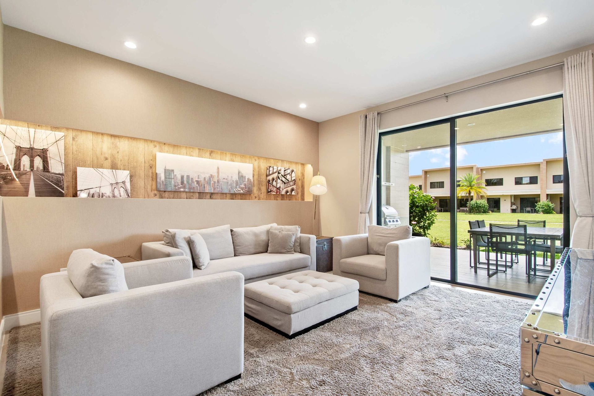Plush sectional seating and cozy rug flow to the covered outdoor patio.