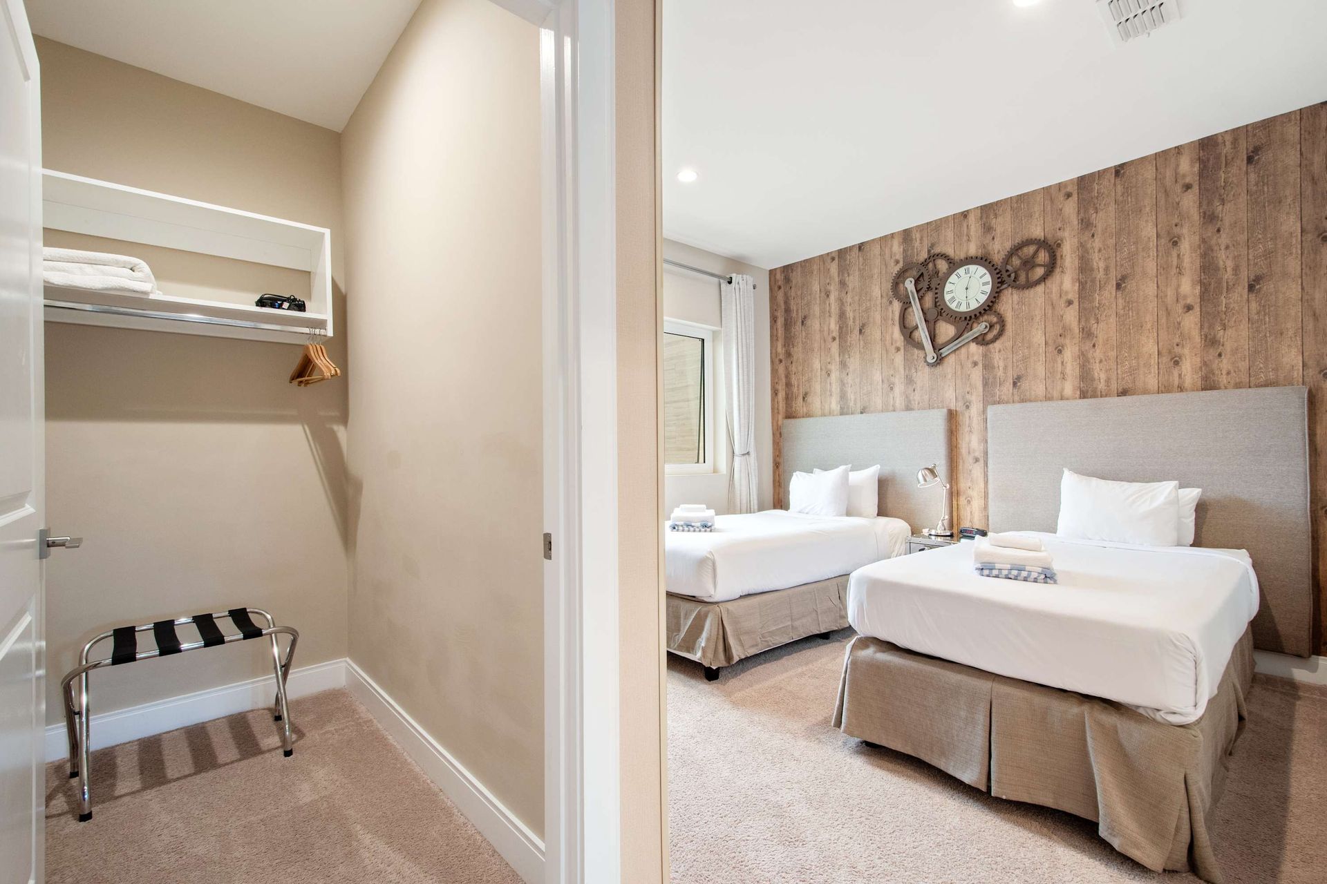 Twin beds, rustic wood wall, and a convenient walk-in closet.