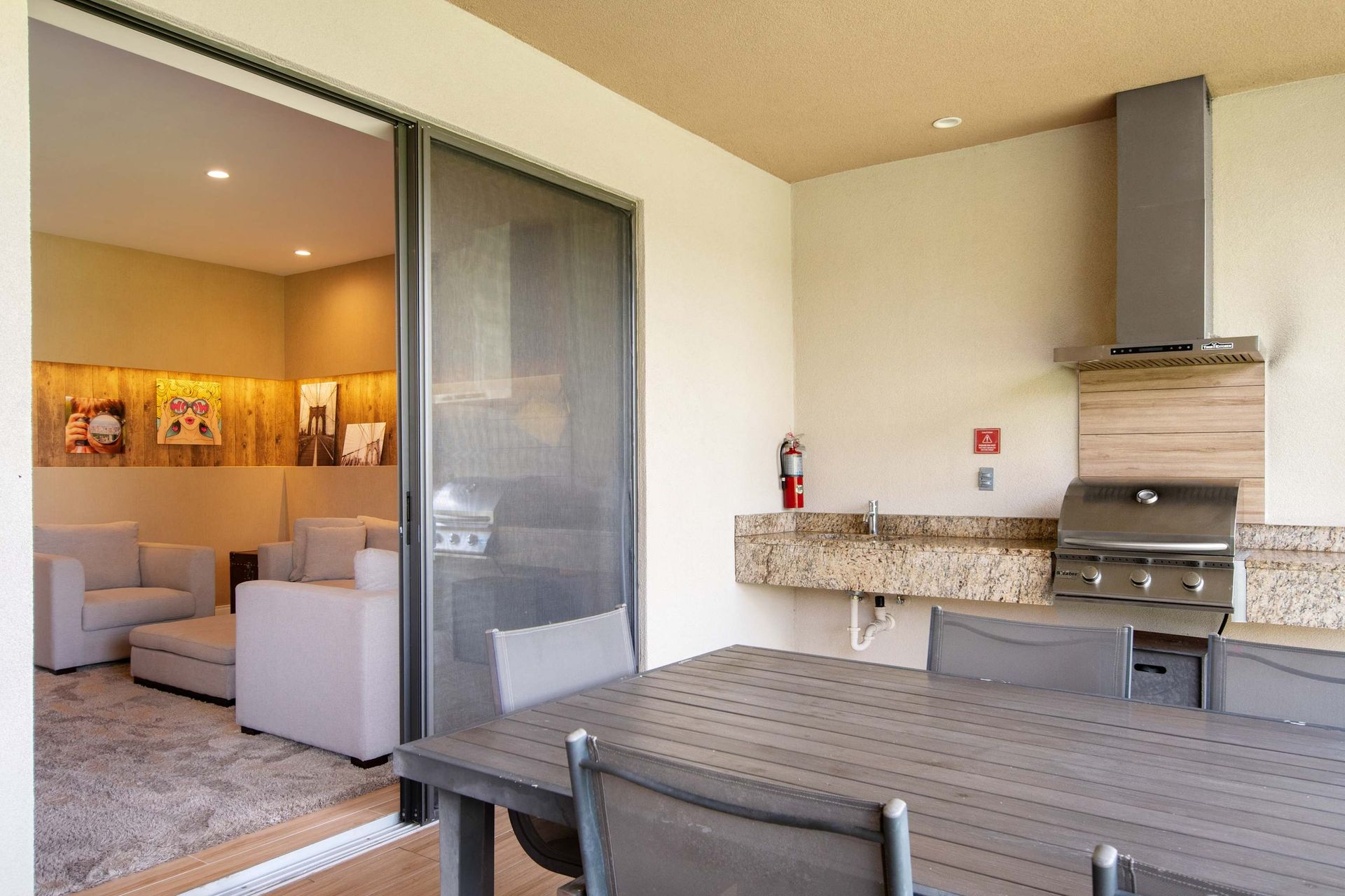 Outdoor kitchen, dining, and grill area opens directly to the lounge.