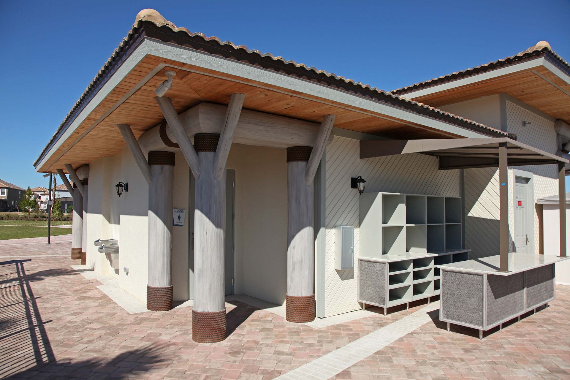 Poolside cabana with changing rooms and storage lockers.
