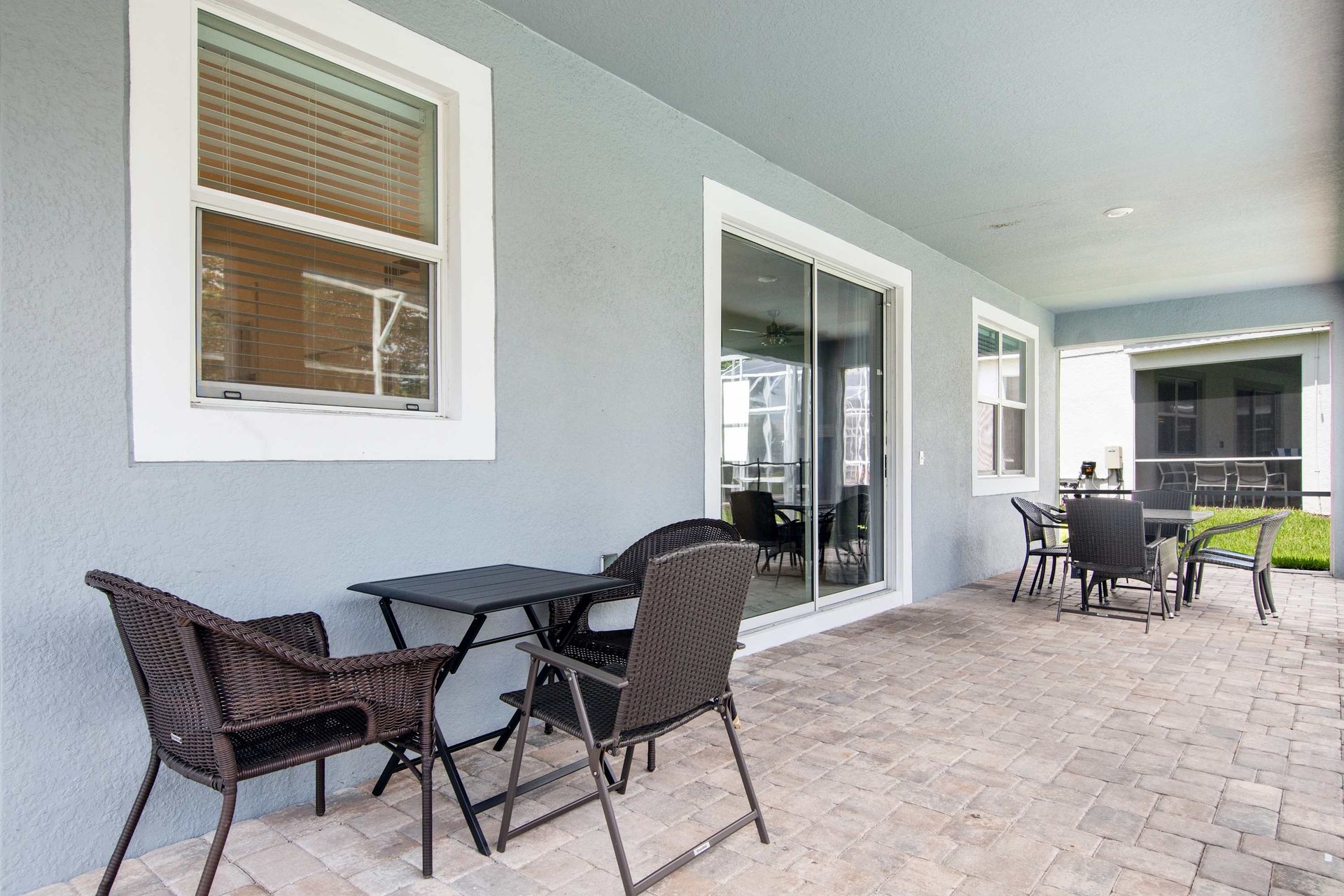 Shaded dining and lounge area overlooks the private, screened pool.