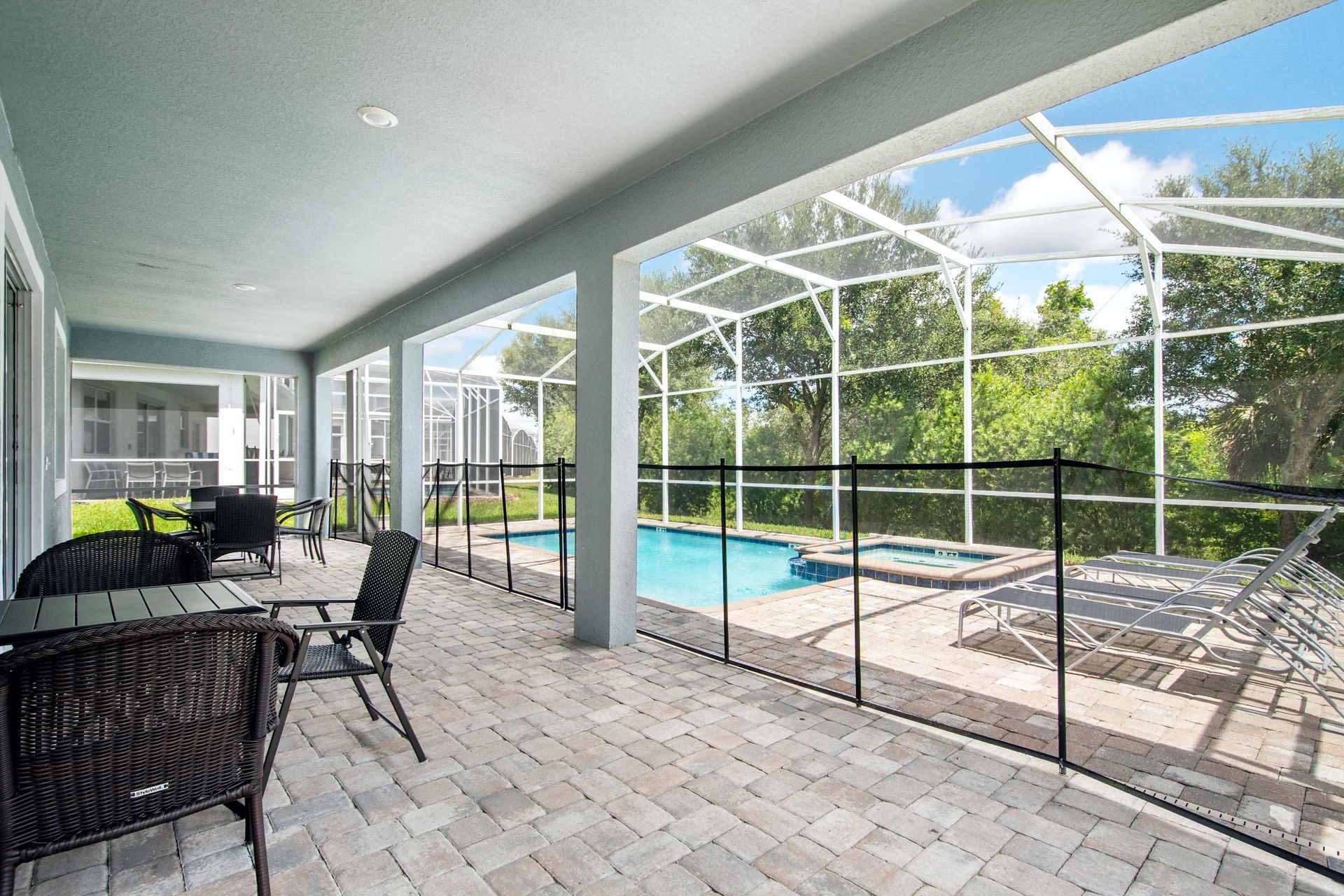Spacious covered patio and fenced pool area for safe outdoor fun.