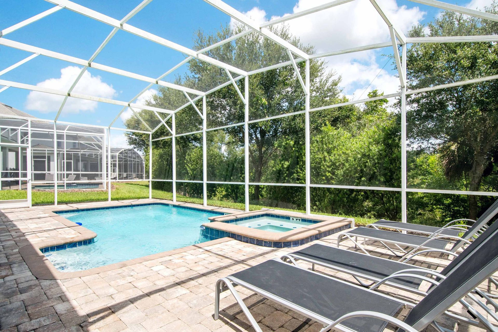Relaxed sun deck with lounge chairs next to the private pool and spa.