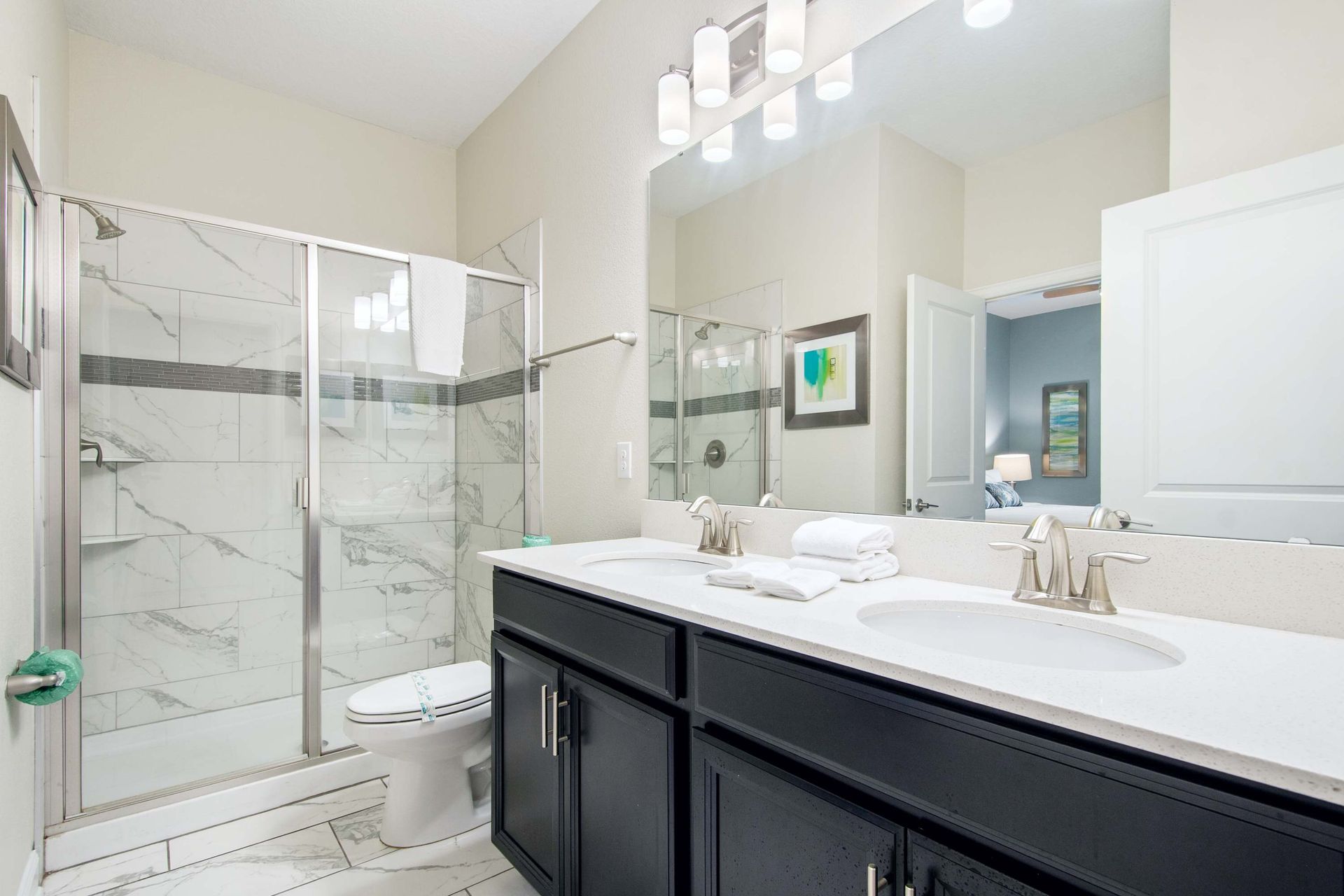 Clean and modern: dual sink vanity with bold dark cabinetry.