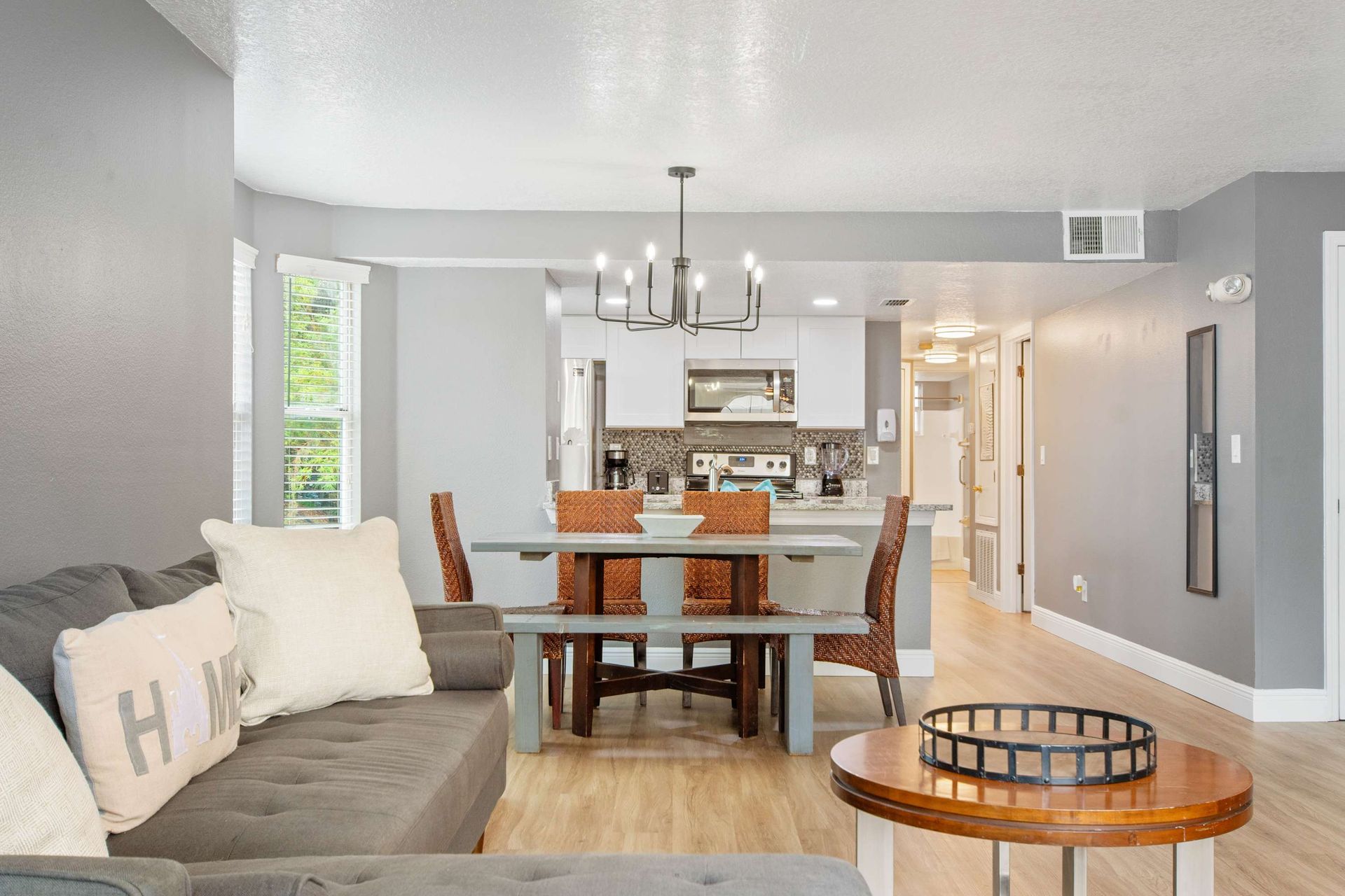 Seamless flow from the cozy couch to the dining table and kitchen.