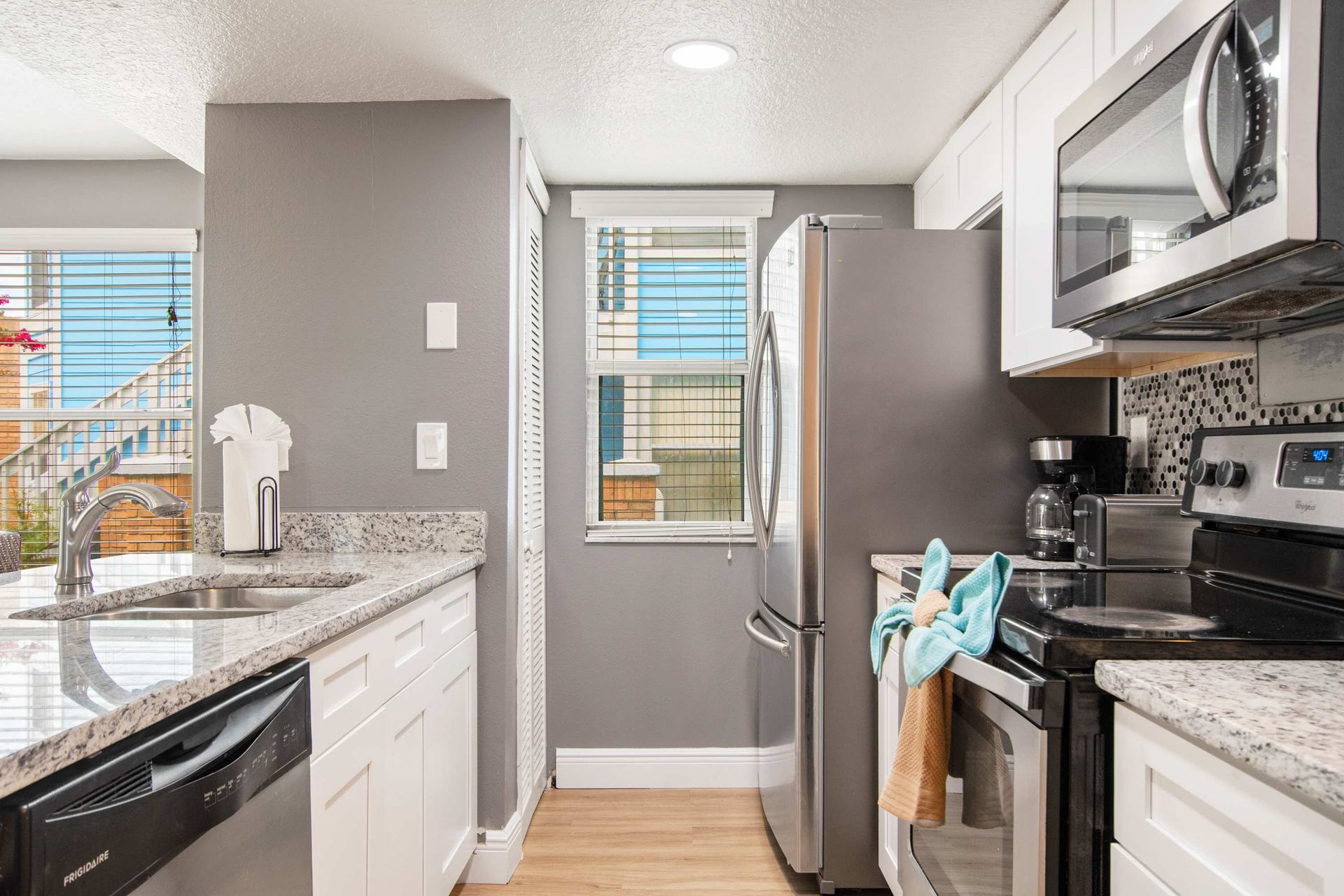 Modern kitchen with stainless steel appliances and granite counters.