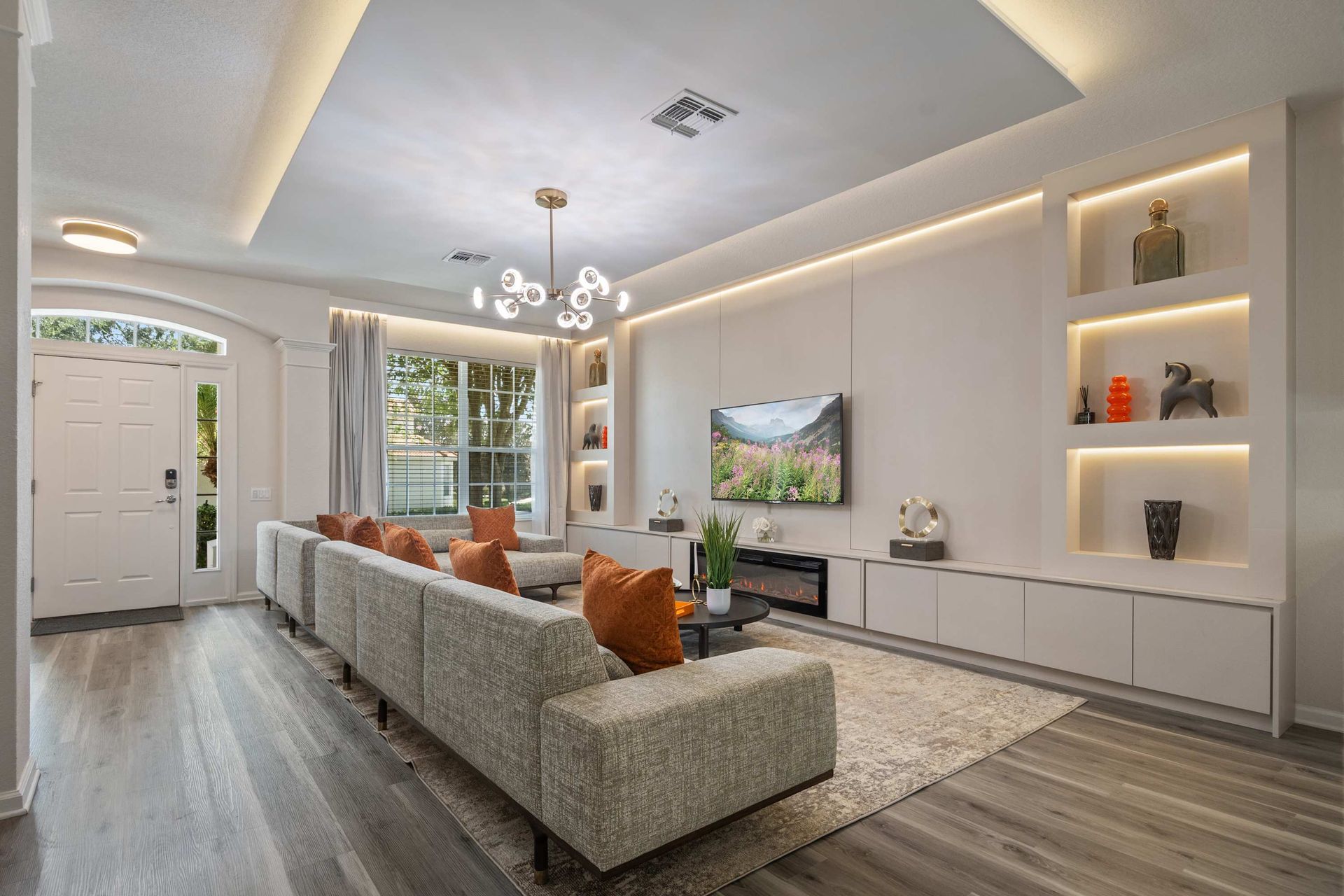 Modern luxury living with accent lighting and a chic, huge sofa.