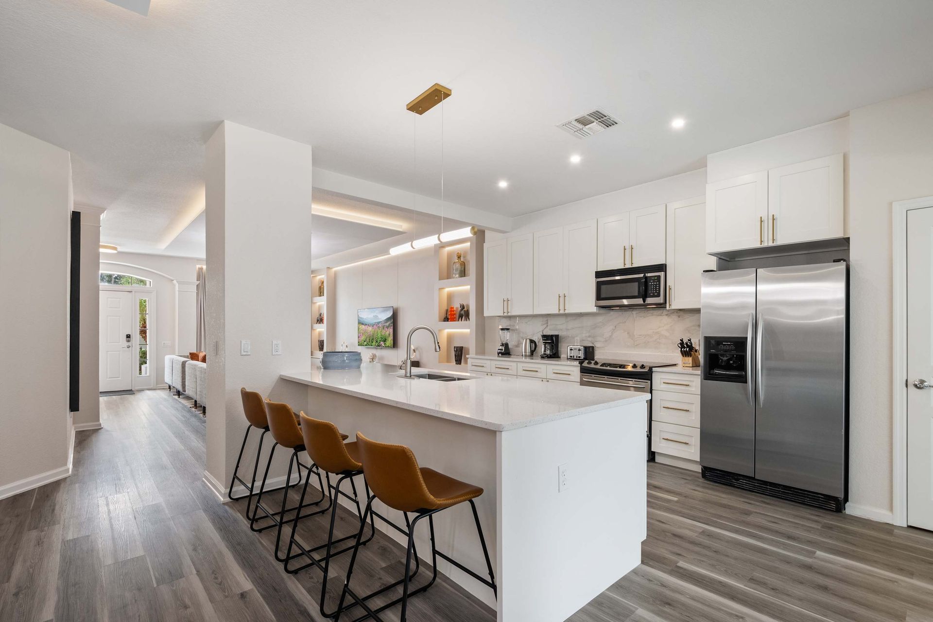 Bright, modern kitchen with full appliances and island seating.