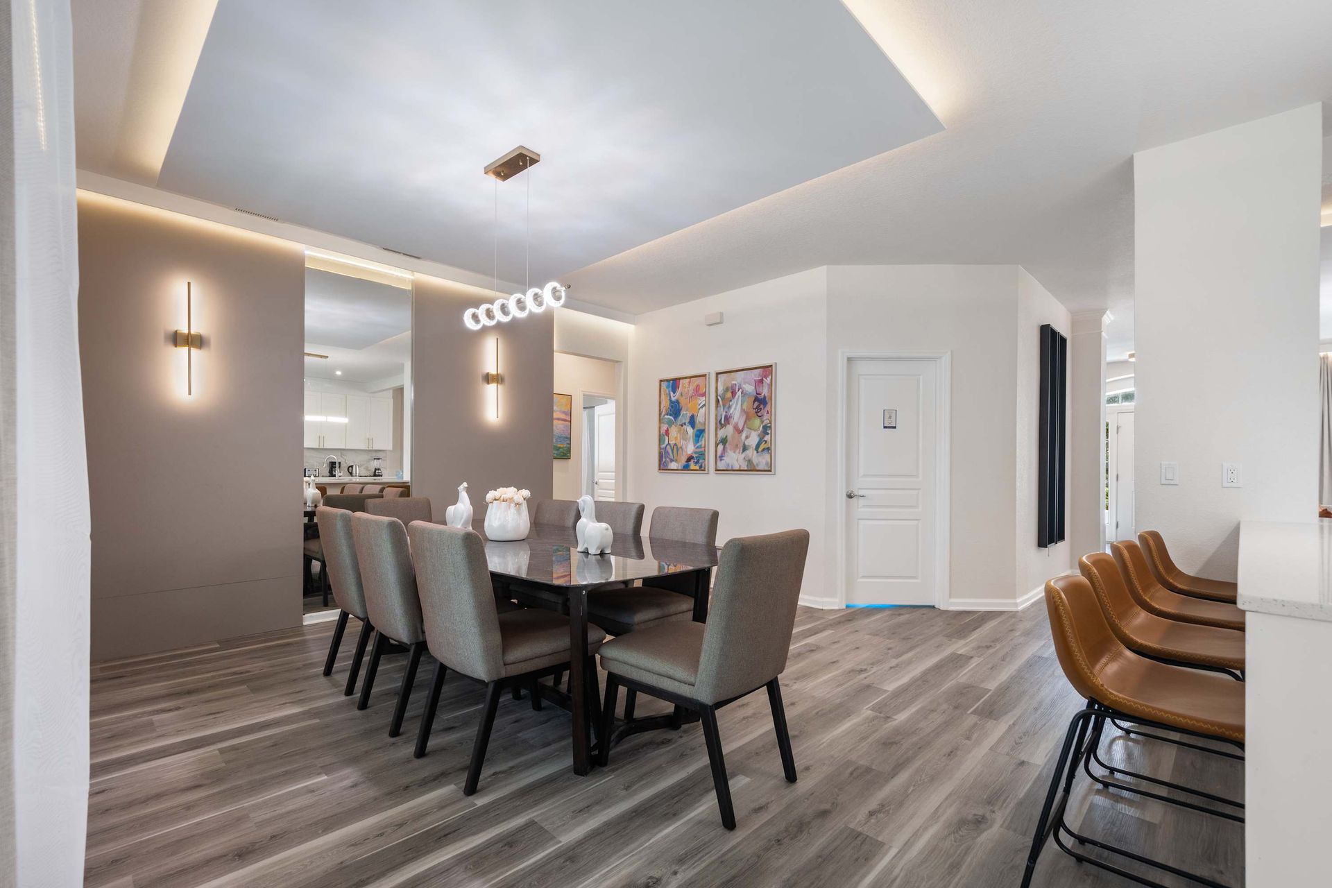 Chic dining room with gray velvet chairs and mood lighting.