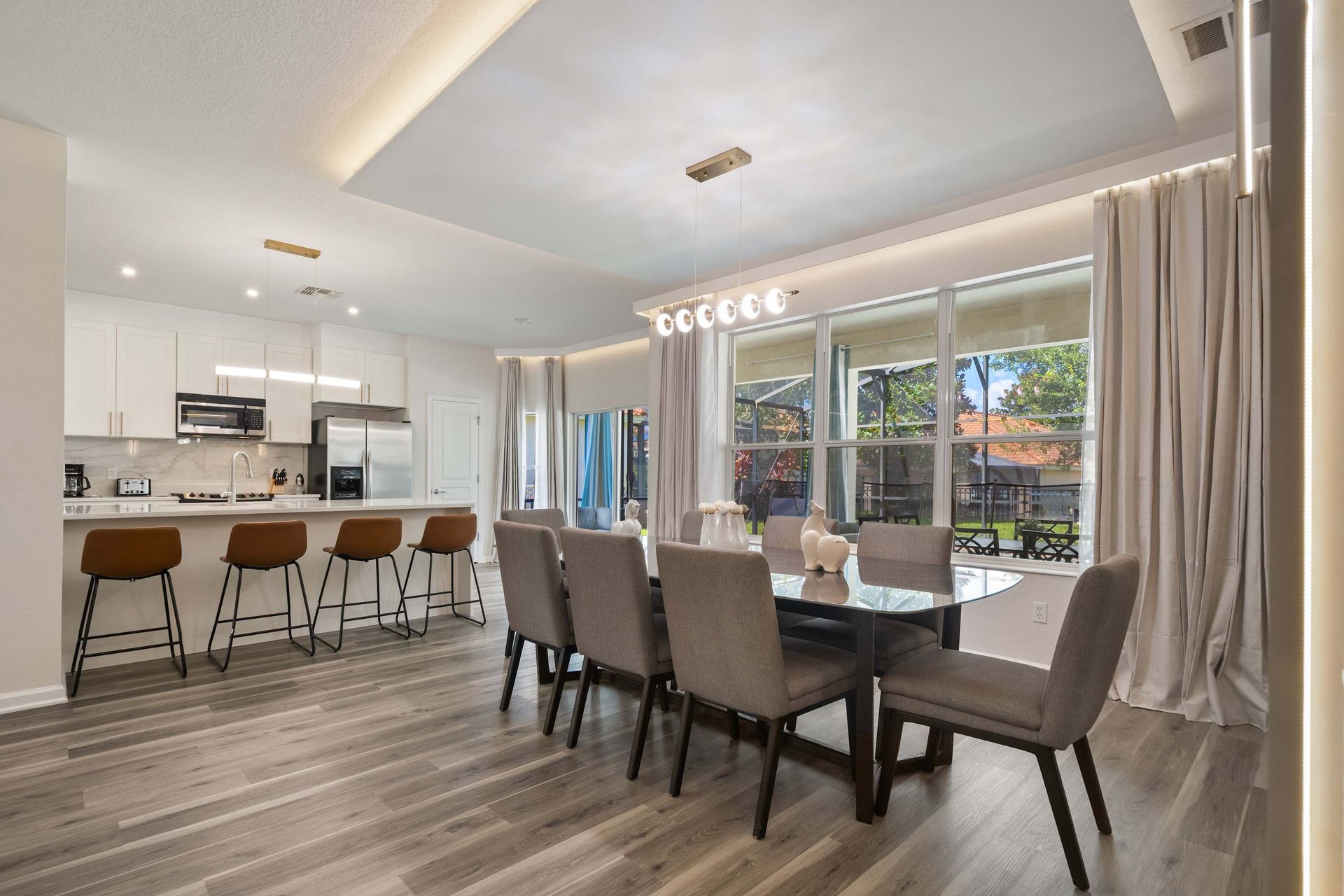 Modern kitchen and dining, brightened by natural light.