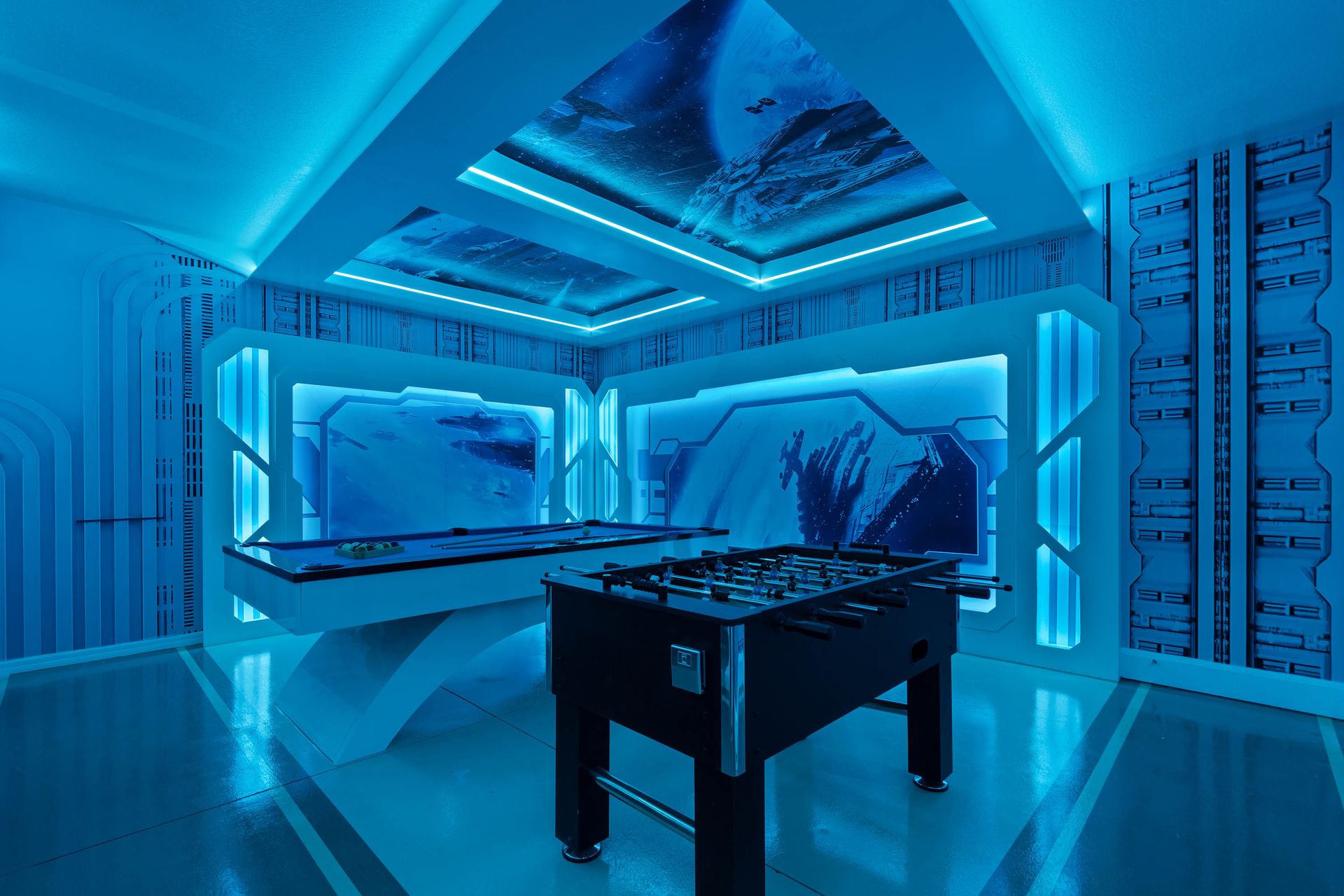 High-tech game room with a glowing ceiling mural.