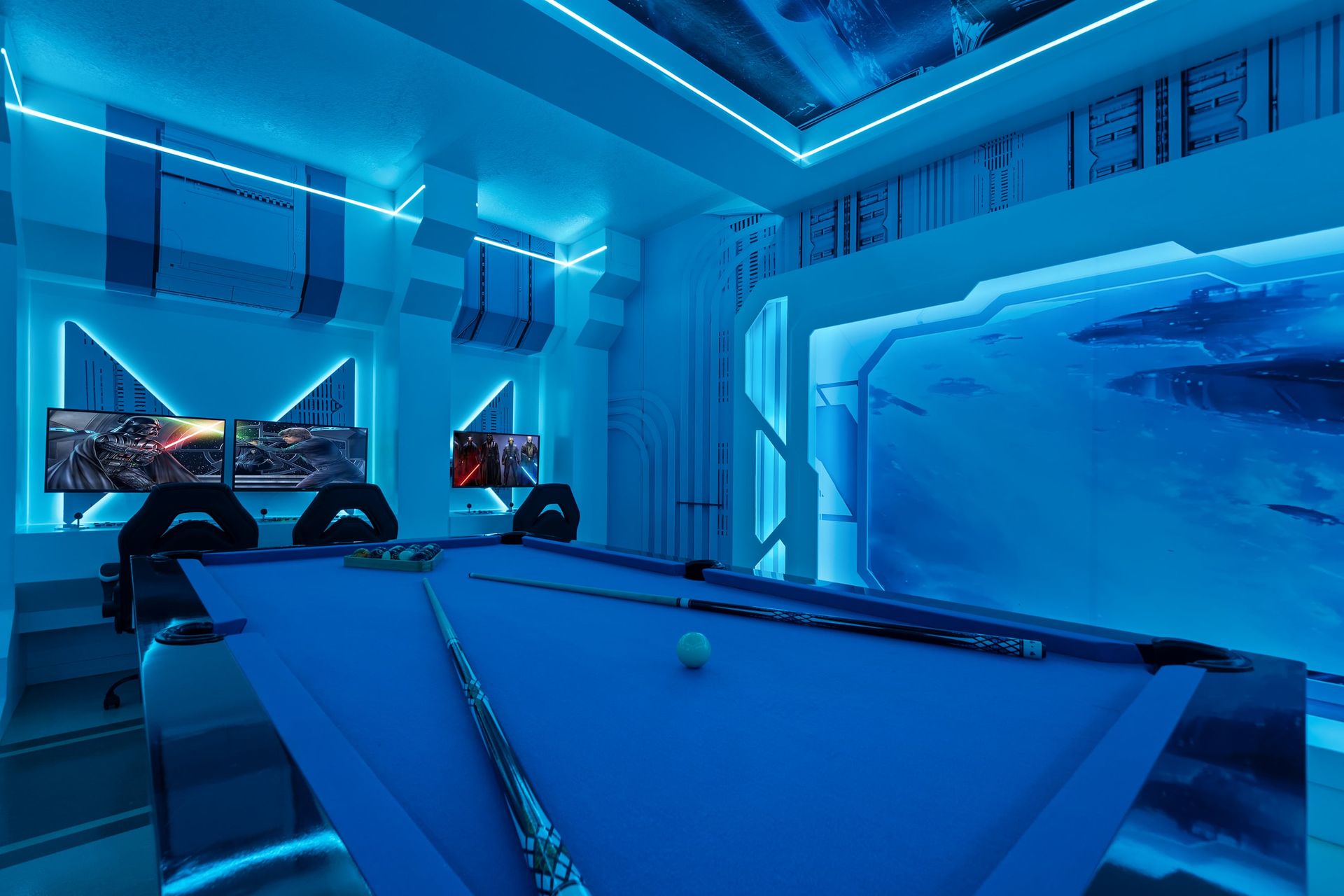 Electric blue light, pool table, and ultimate gaming setup.