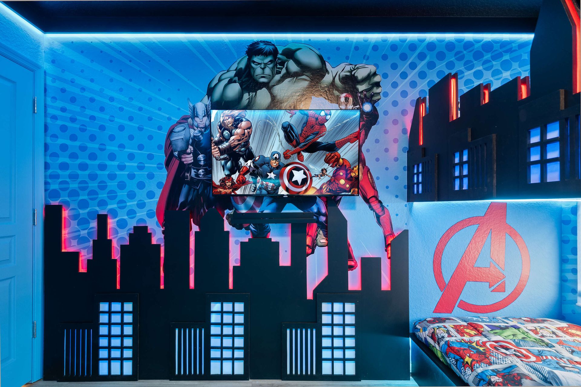 Custom superhero media wall and vibrant theme lighting.