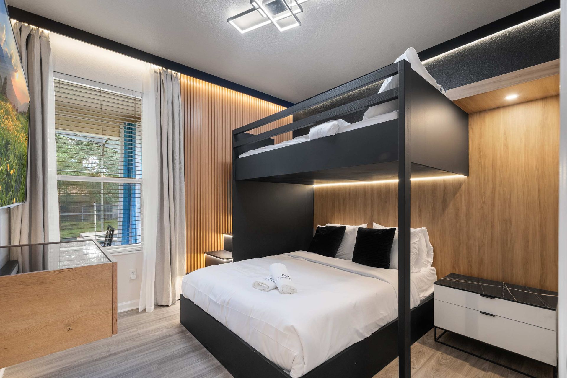 Wood paneling and backlighting create a cozy, chic sleeping area.