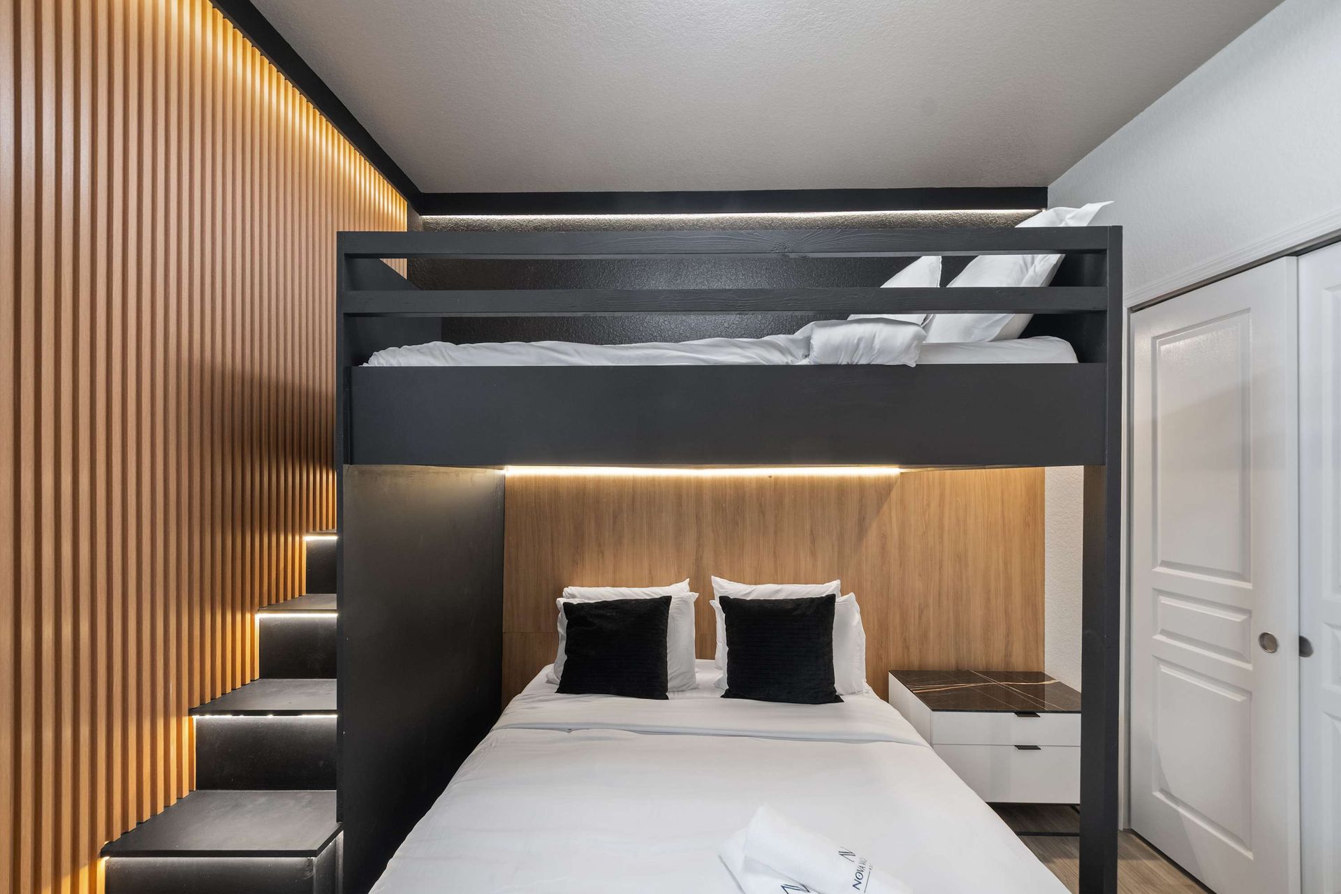 Black and wood tones define this modern, space-saving bedroom.