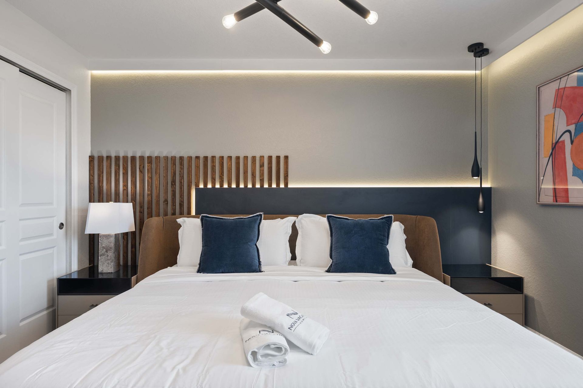 Contemporary king bed with soft backlighting for ultimate comfort.