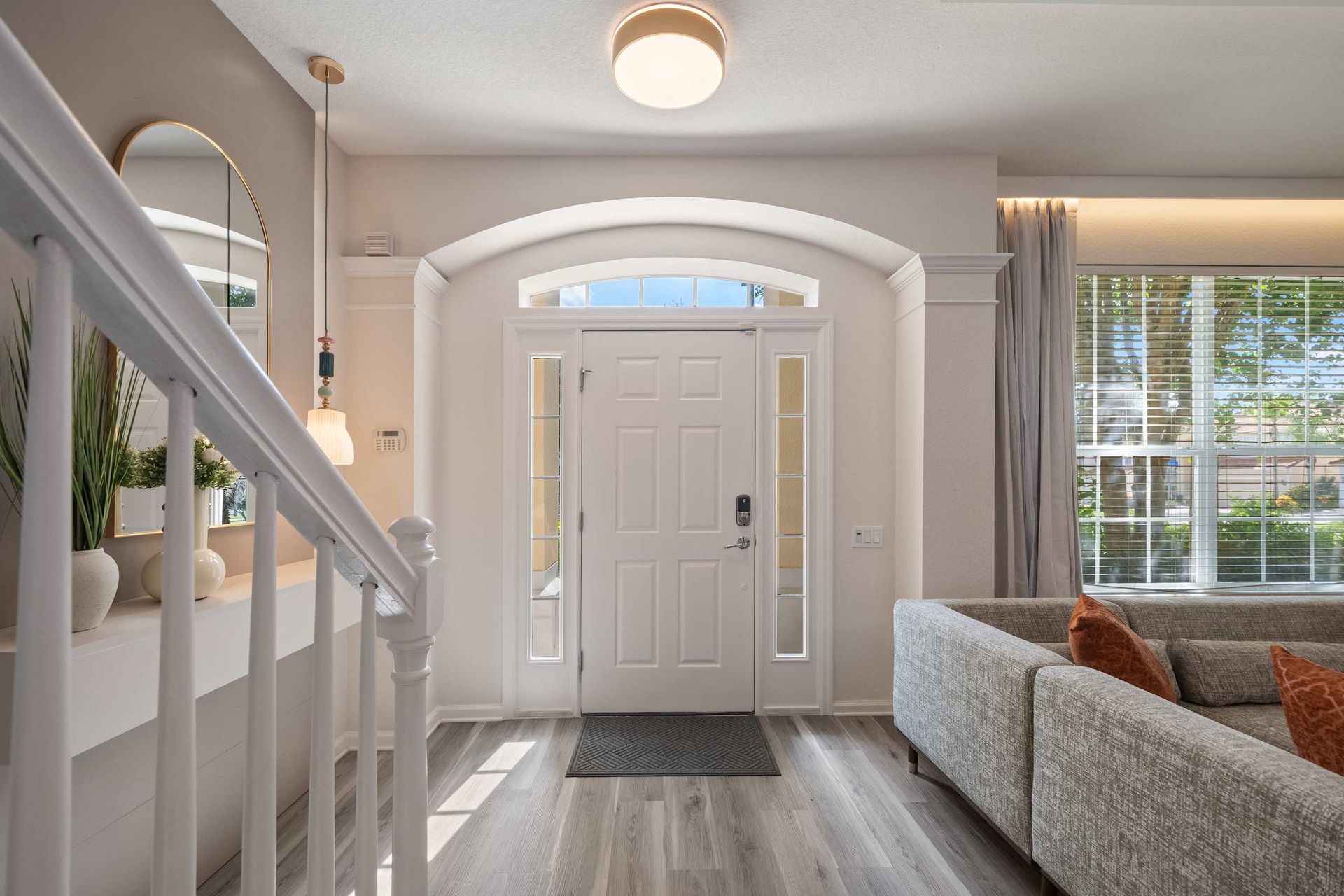Bright, modern entryway leading to the elegant living room.