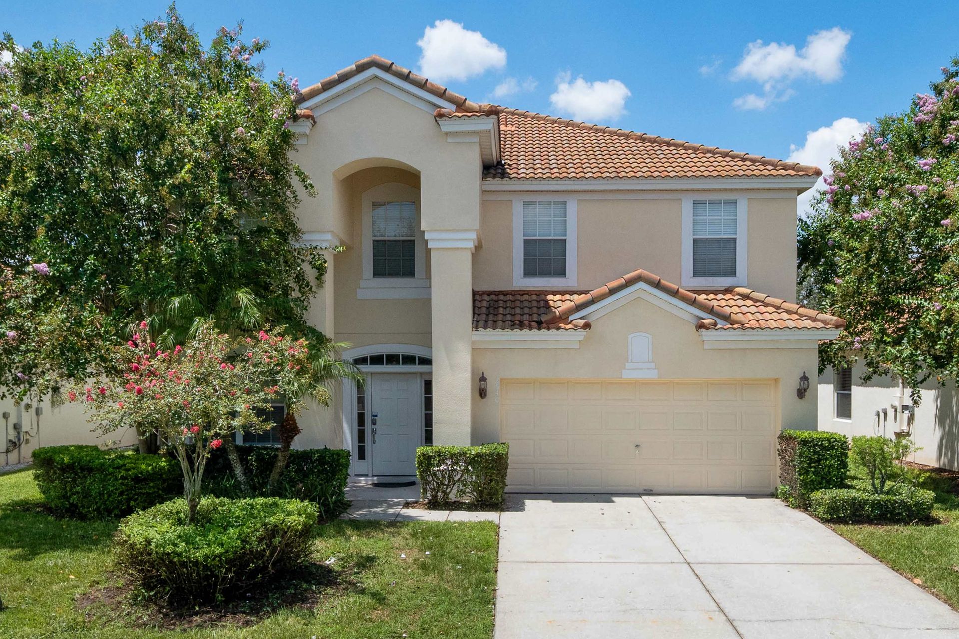 Great curb appeal: bright, welcoming home surrounded by lush landscaping.