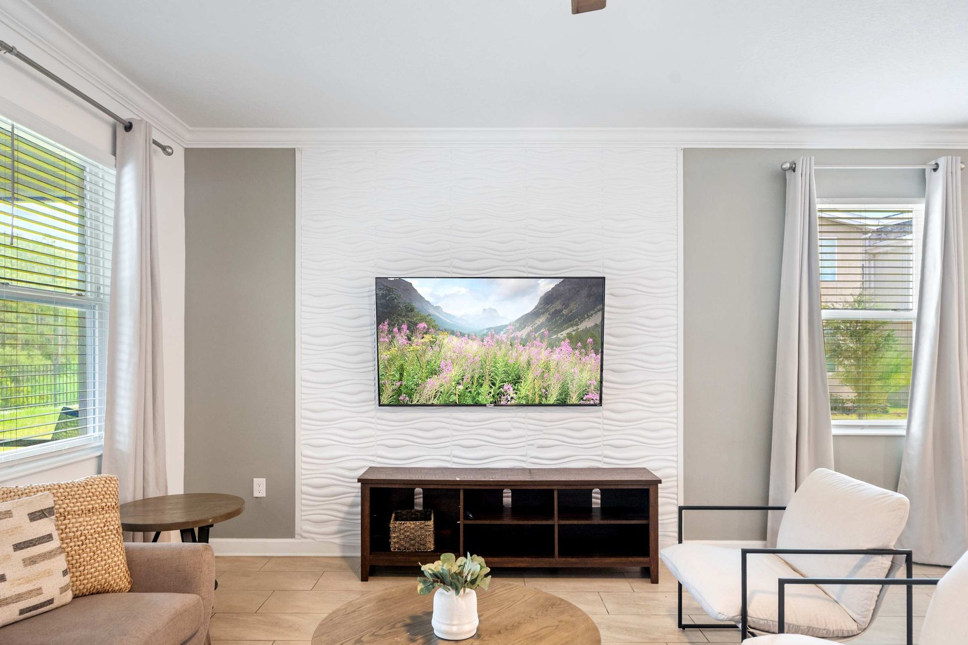 Modern lounge perfect for movie night with a huge wall-mounted screen.