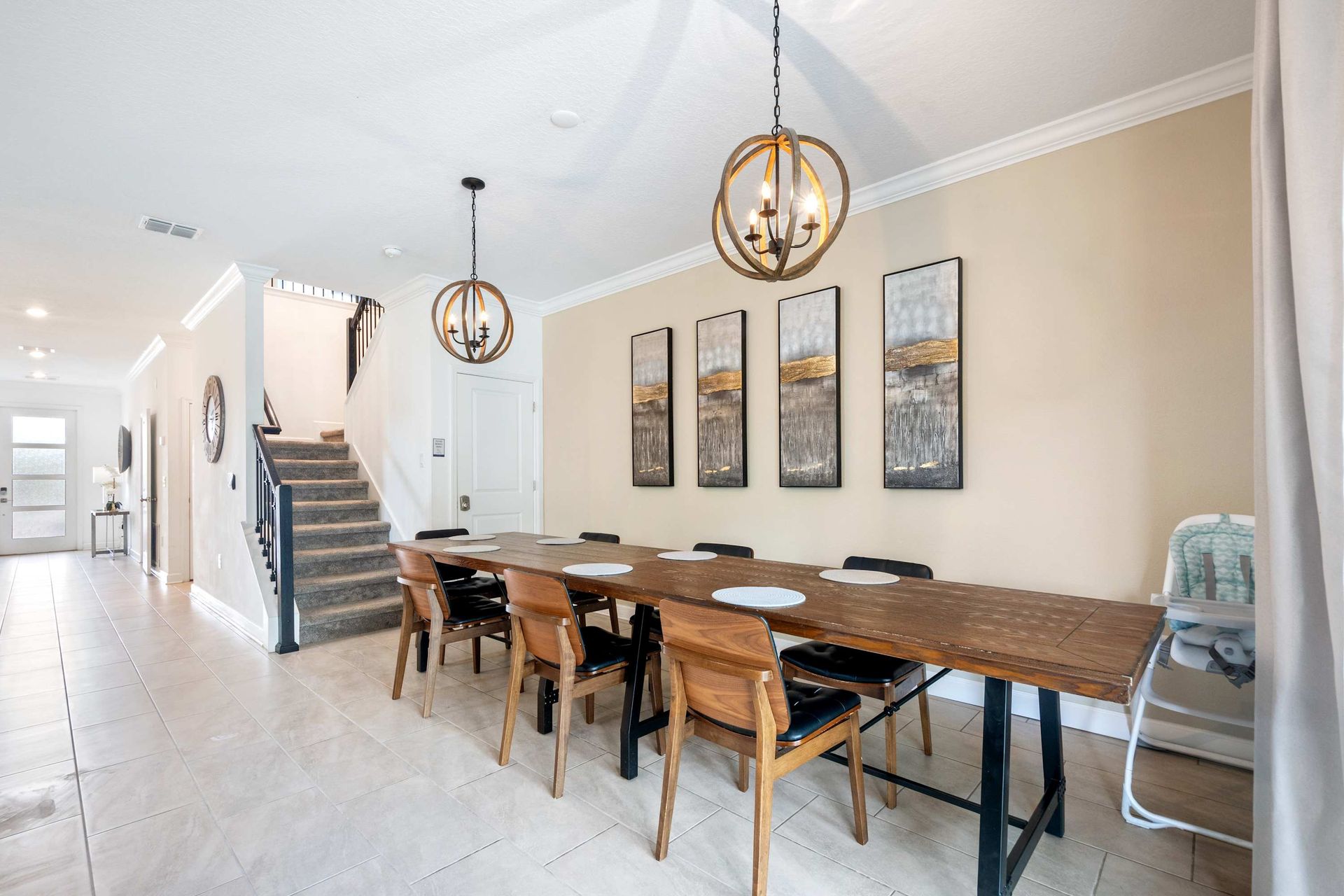 Massive dining table with rustic charm and elegant globe chandeliers.