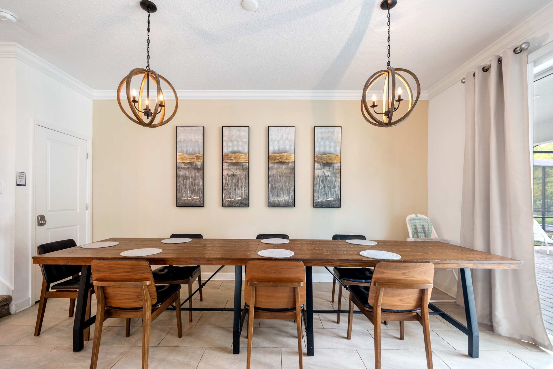 Large farmhouse dining table for eight with stunning orb chandeliers. 