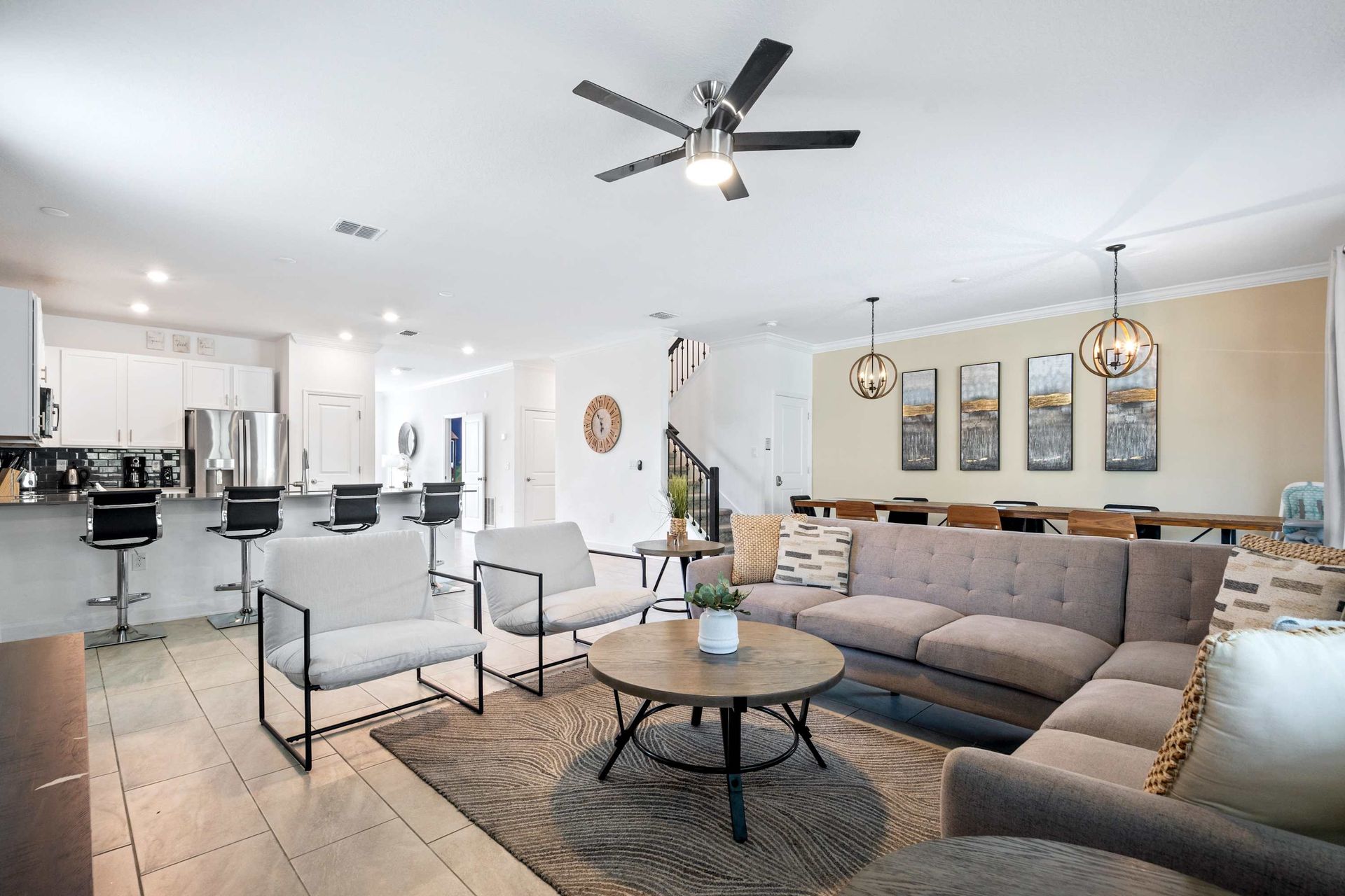 Open-concept living: lounge, dining, and kitchen bar seating flow. 