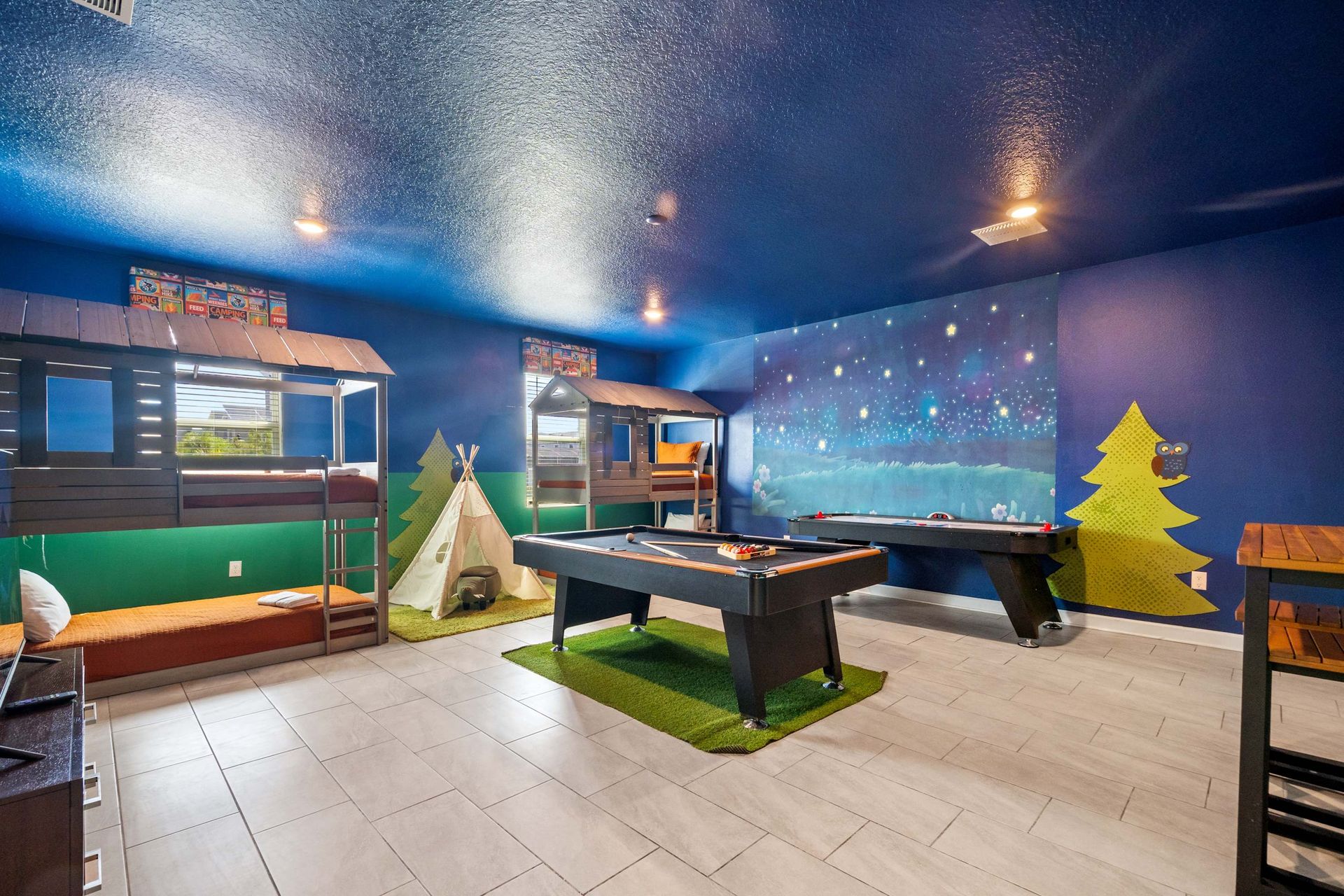 Starry night walls and teepees create a fun indoor camping adventure. 