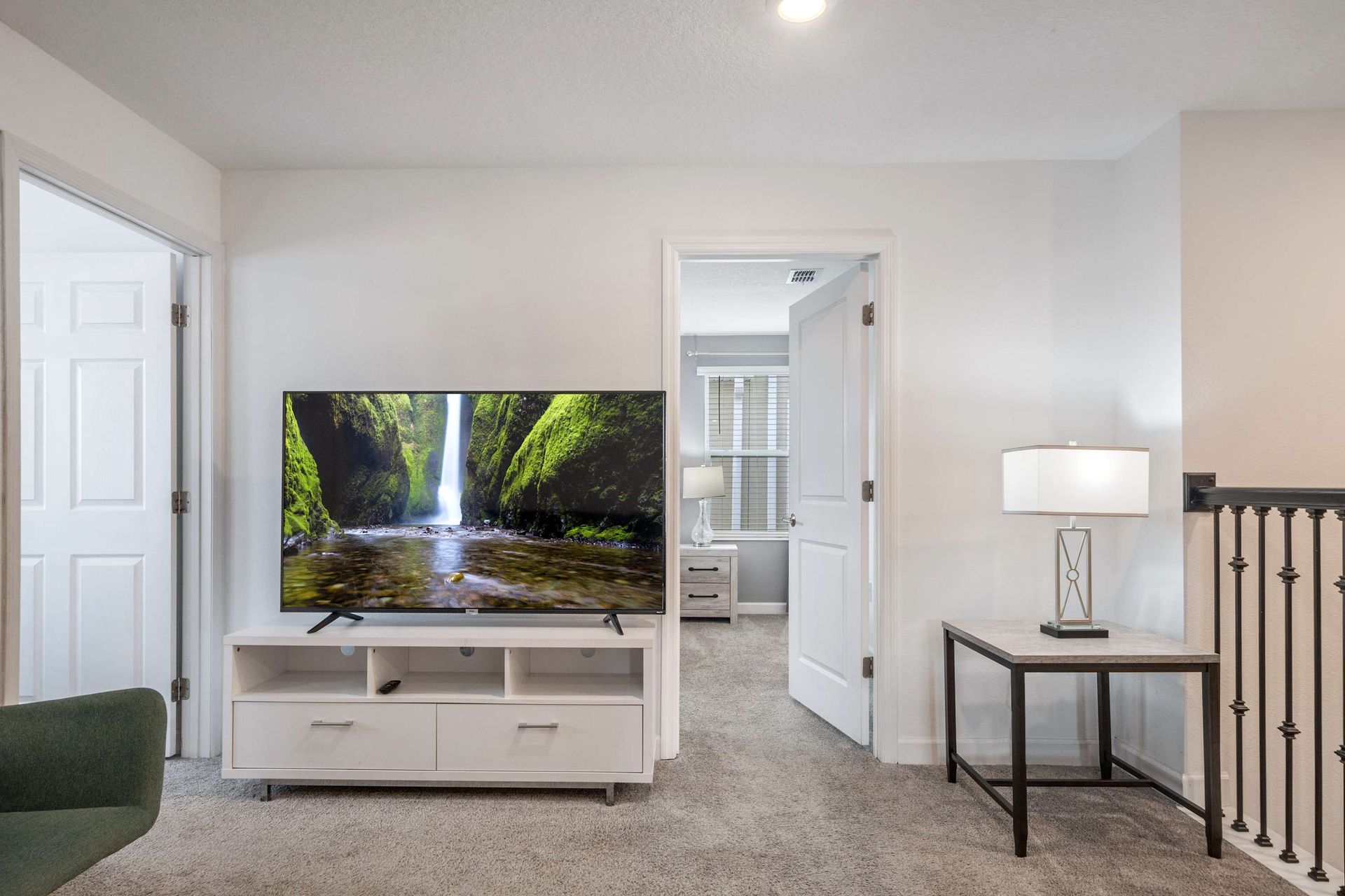 Upper-floor lounge with a large TV and easy access to bedrooms.