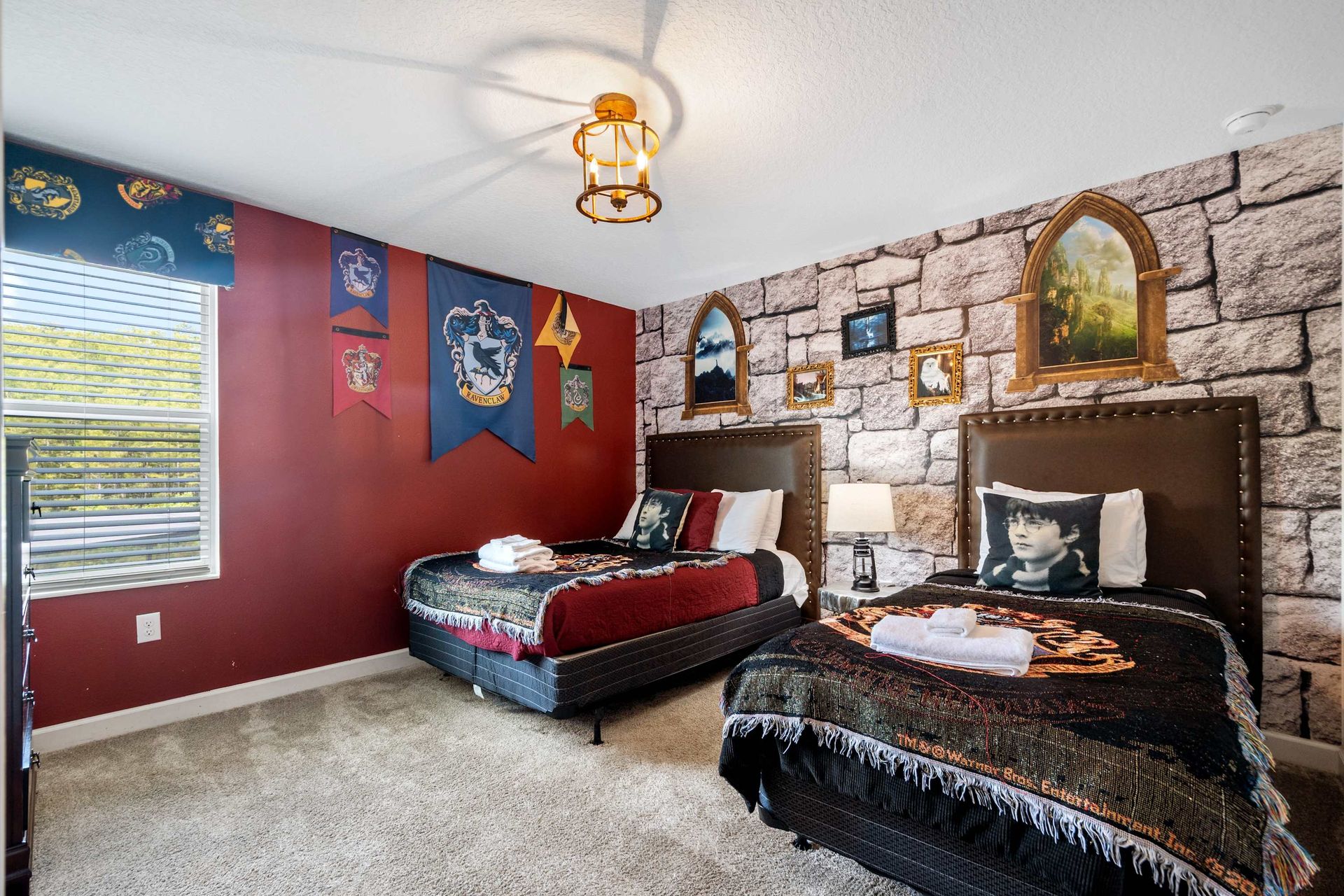 Twin full beds, stone castle wall, and house banners for a magical stay. 