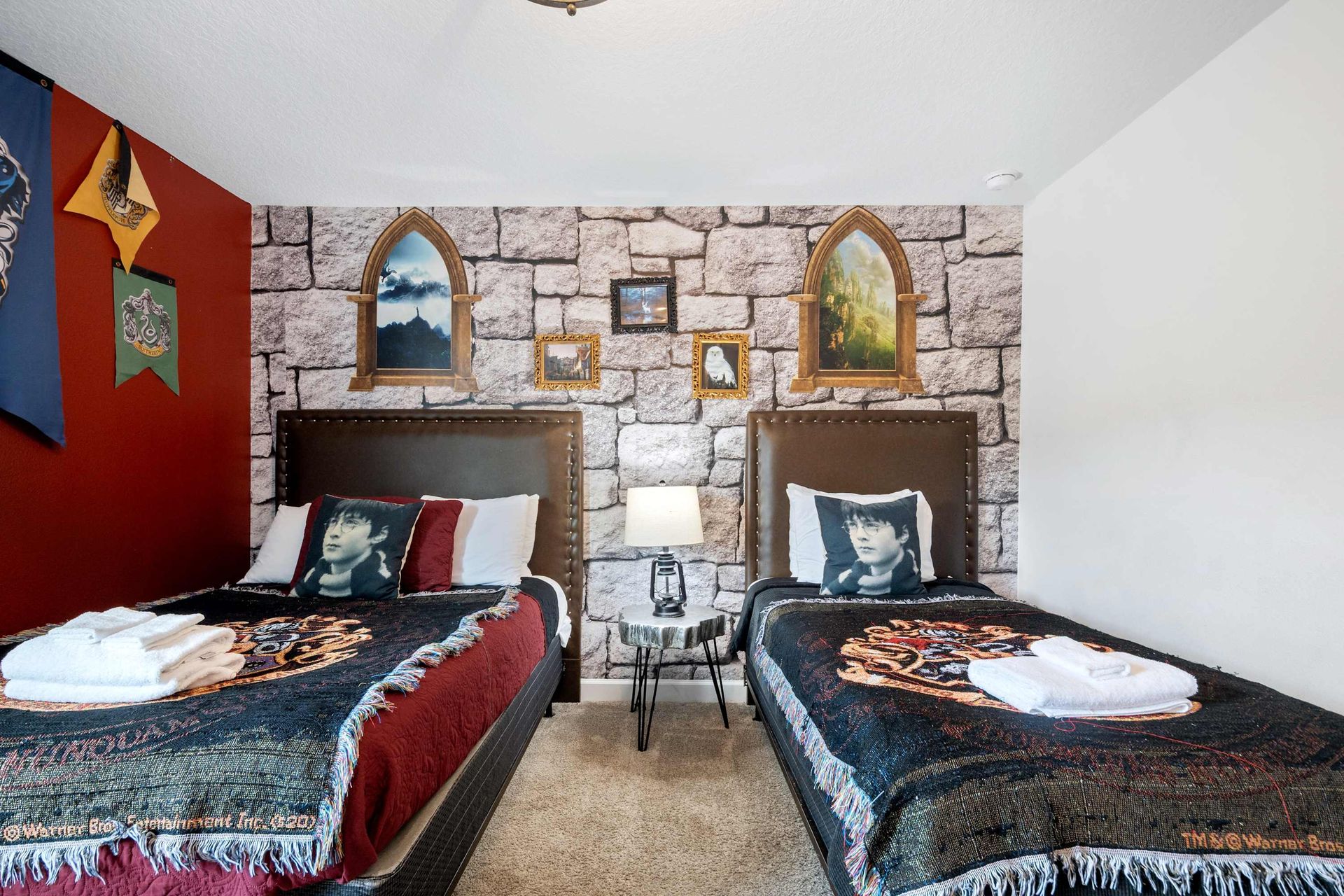 Twin beds, stone walls, and house banners for a magical night's sleep.