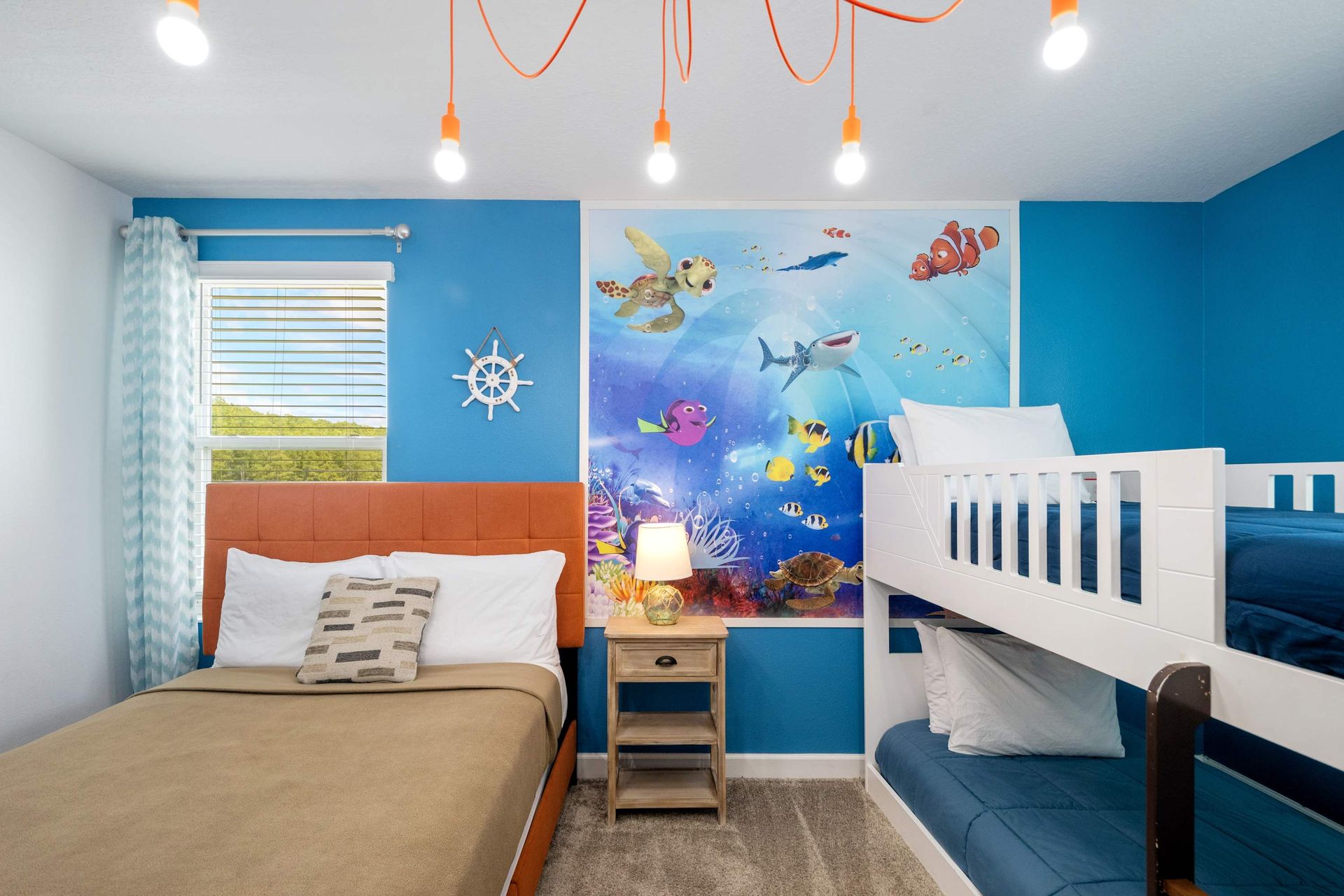 Underwater fun! Bunk bed and full bed with a vibrant ocean mural.