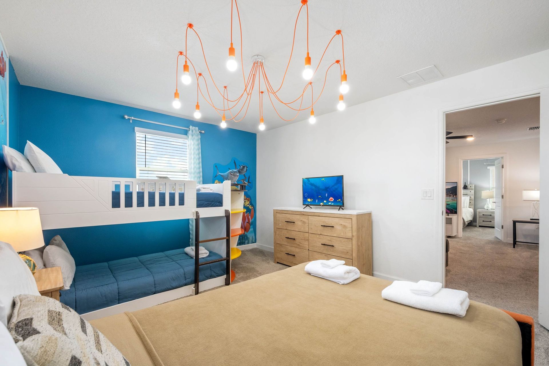 Twin-over-full bunk and a queen bed for a fun, flexible family room. 