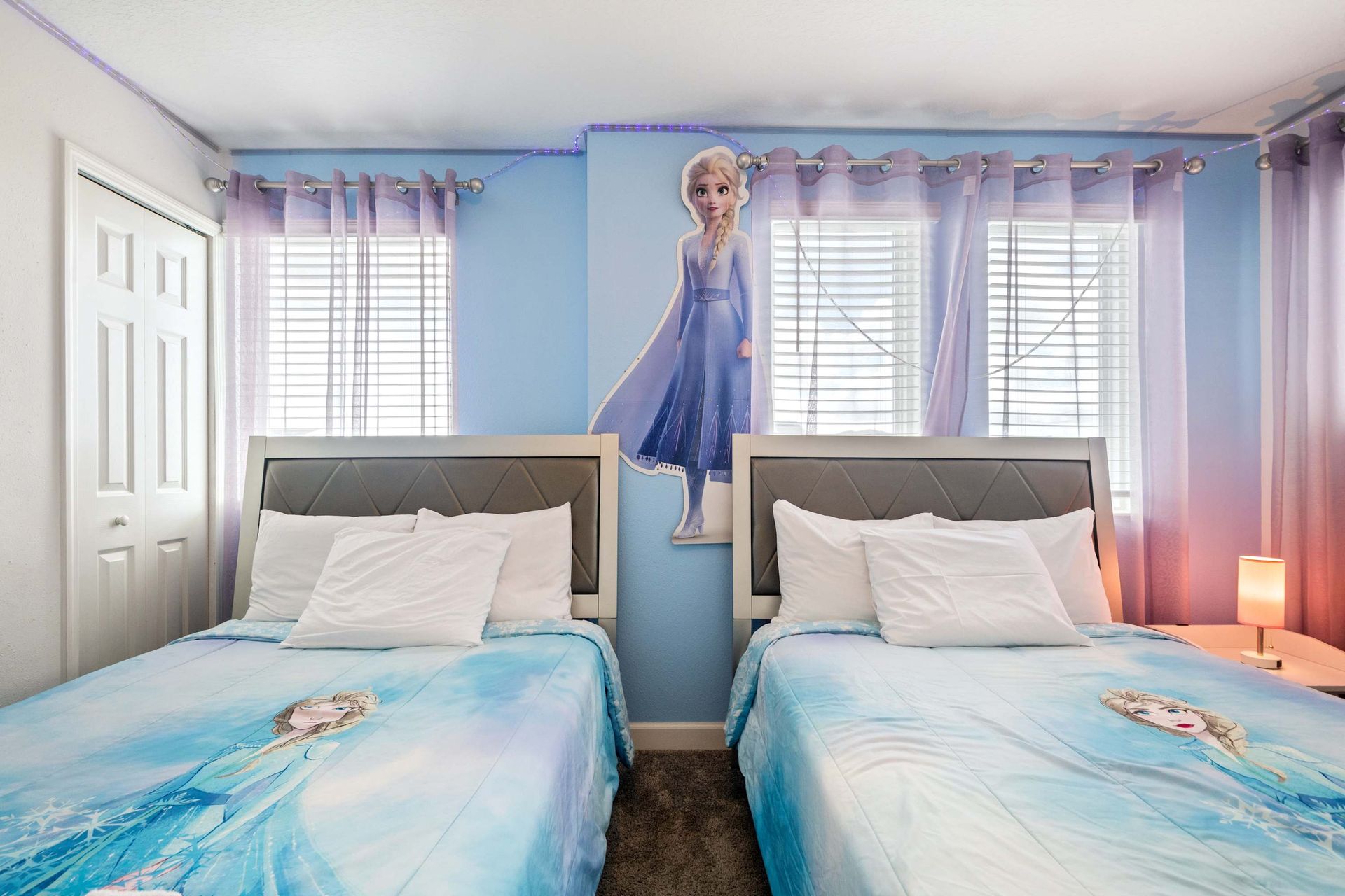 Twin beds in a magical frozen room with a popular princess theme. 