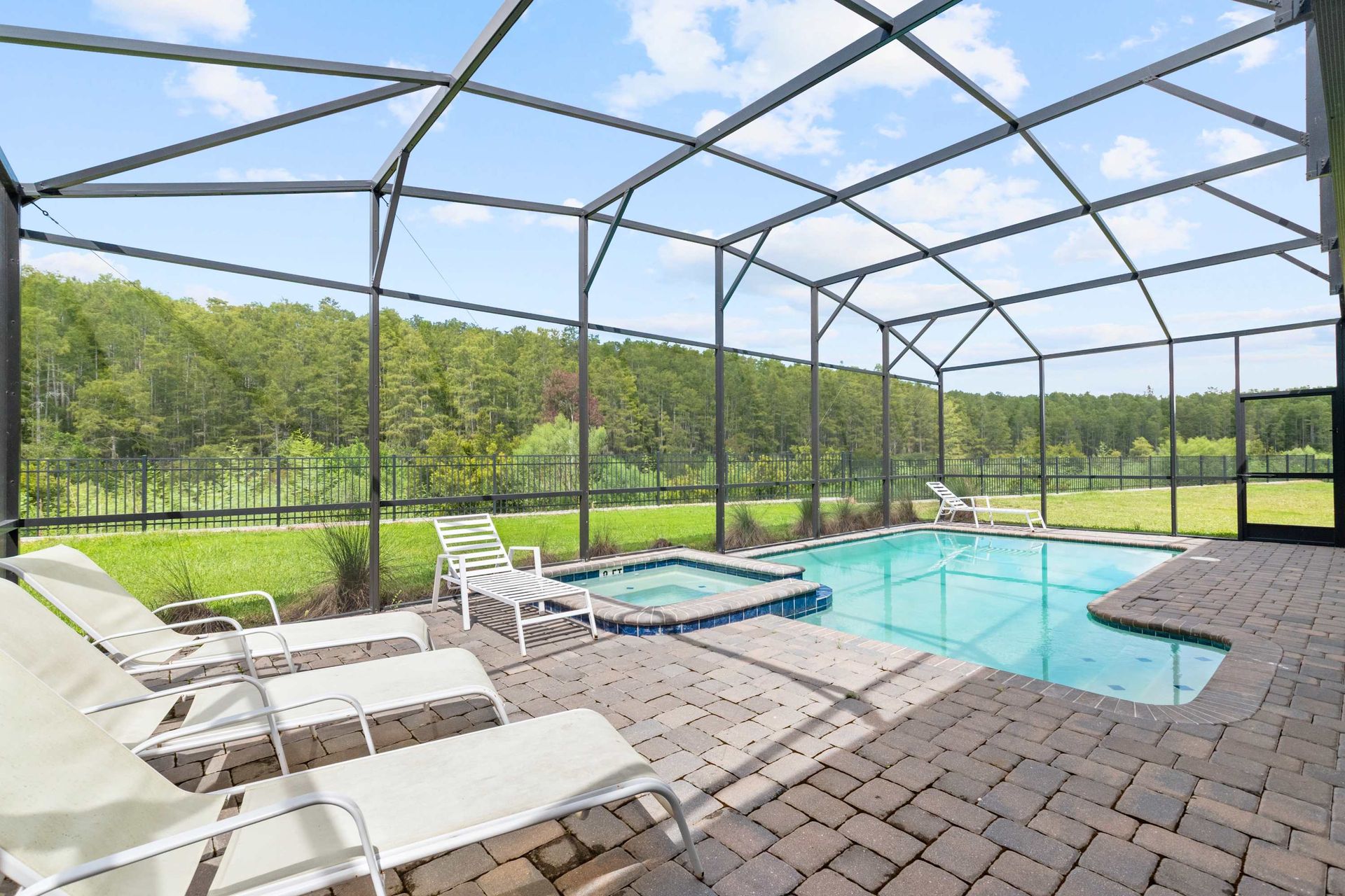 Private oasis: sparkling pool, bubbling spa, and plenty of loungers. 
