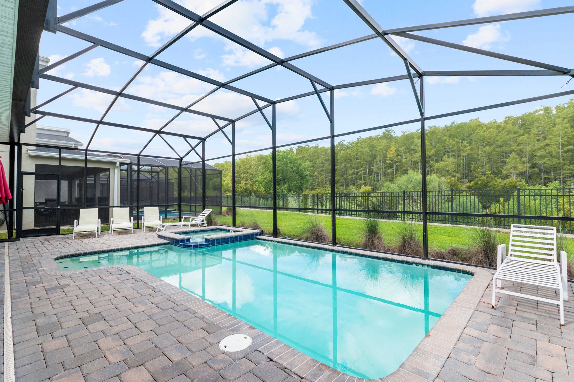 Private screened pool and spa with a stunning view of the forest. 