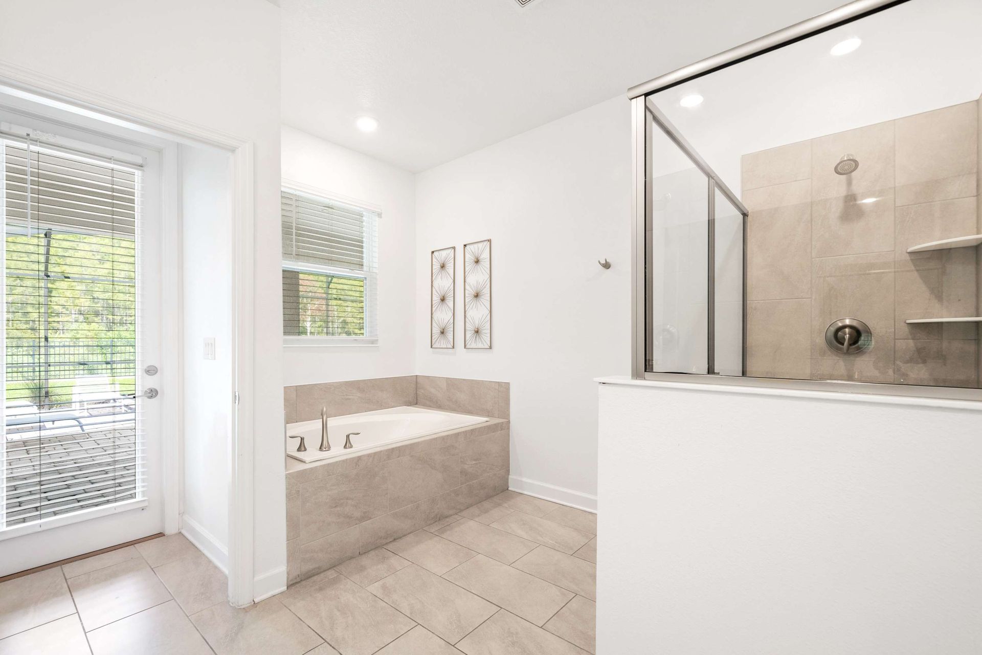 Bright, elegant master bath with natural light and tub. 