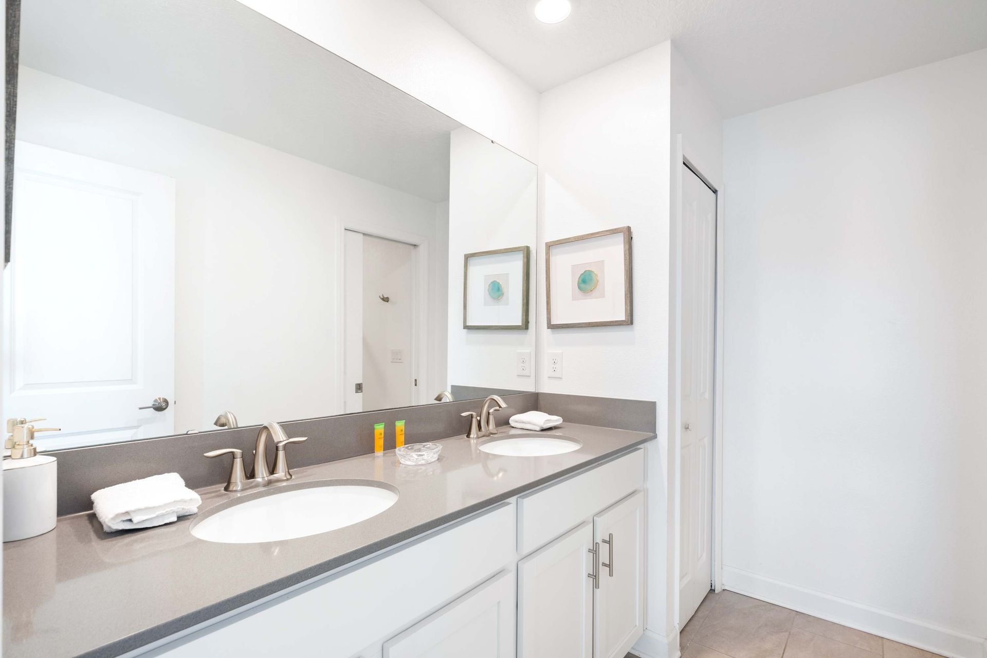 Dual vanity, sleek counters, and direct access to the patio/pool area. 