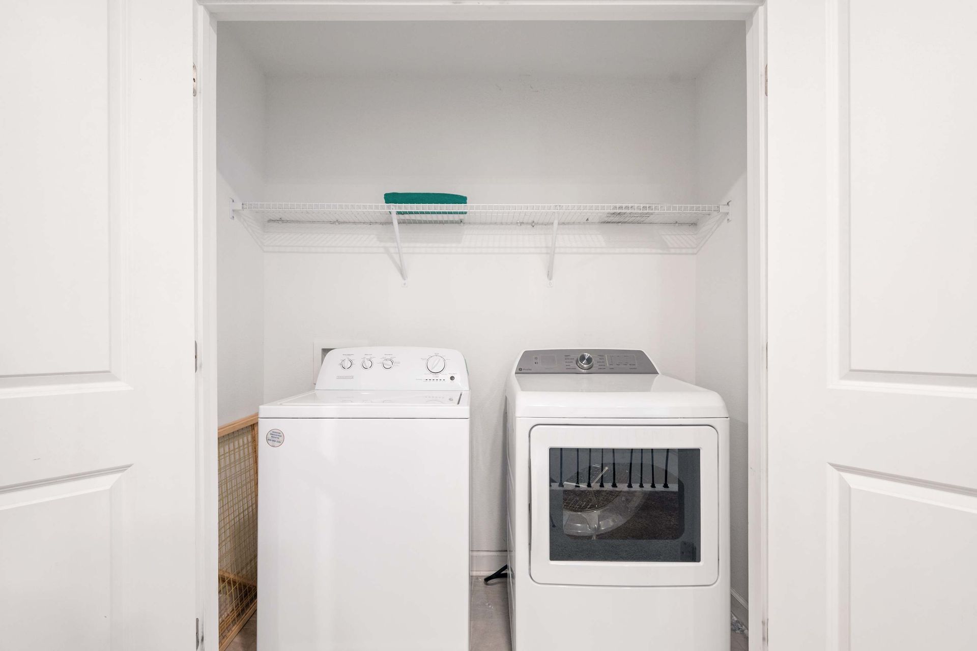 In-unit laundry closet with full-size washer and dryer for convenience. 