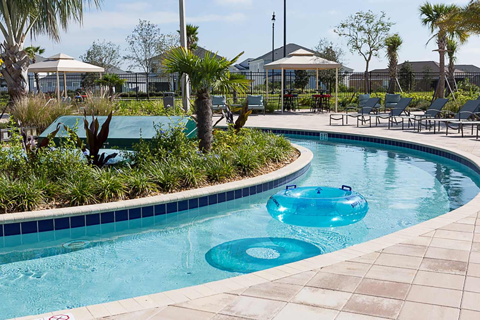 Sunny skies and palm trees line the resort's serene lazy river.