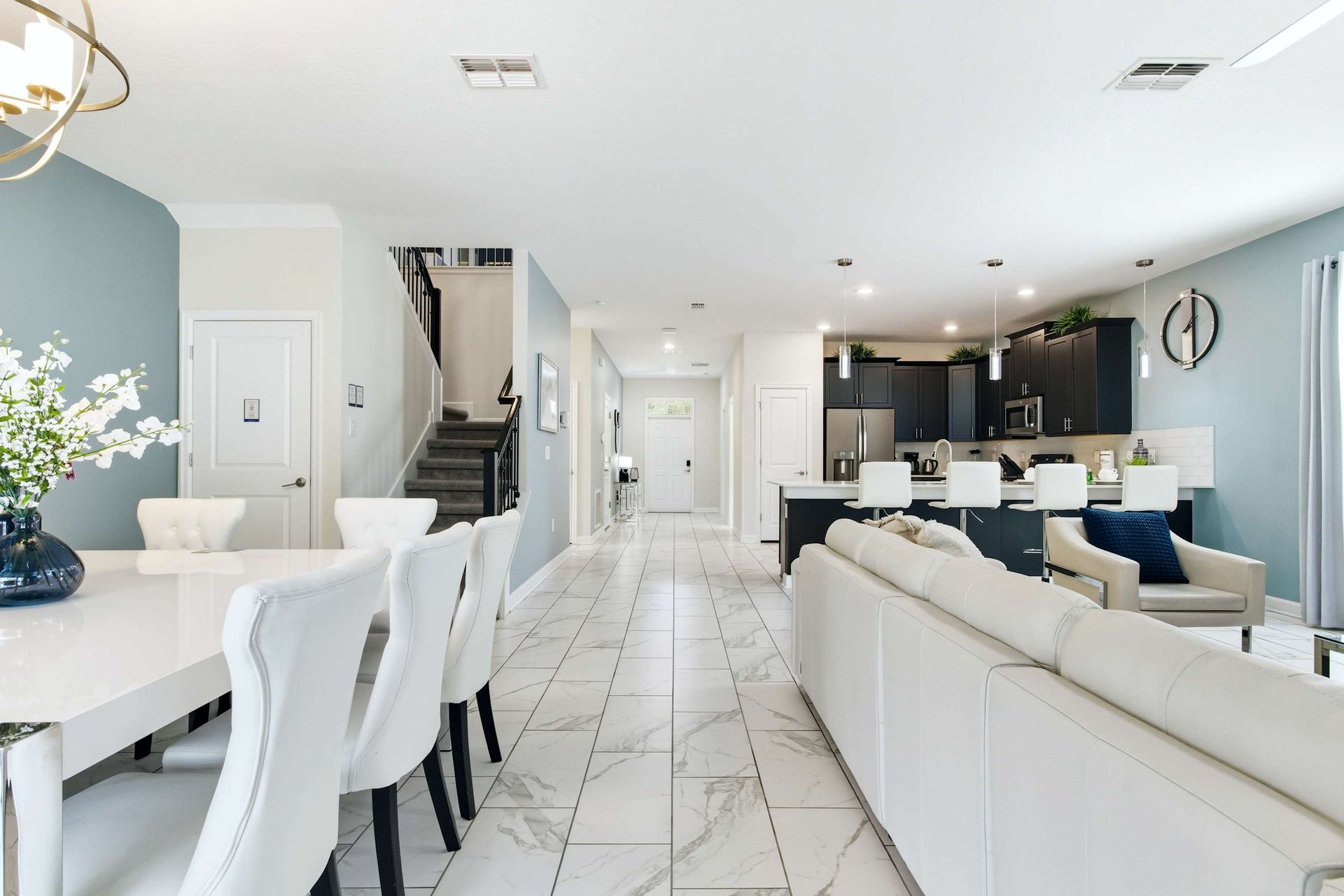 Long, open floor plan flows from dining to kitchen bar and lounge.