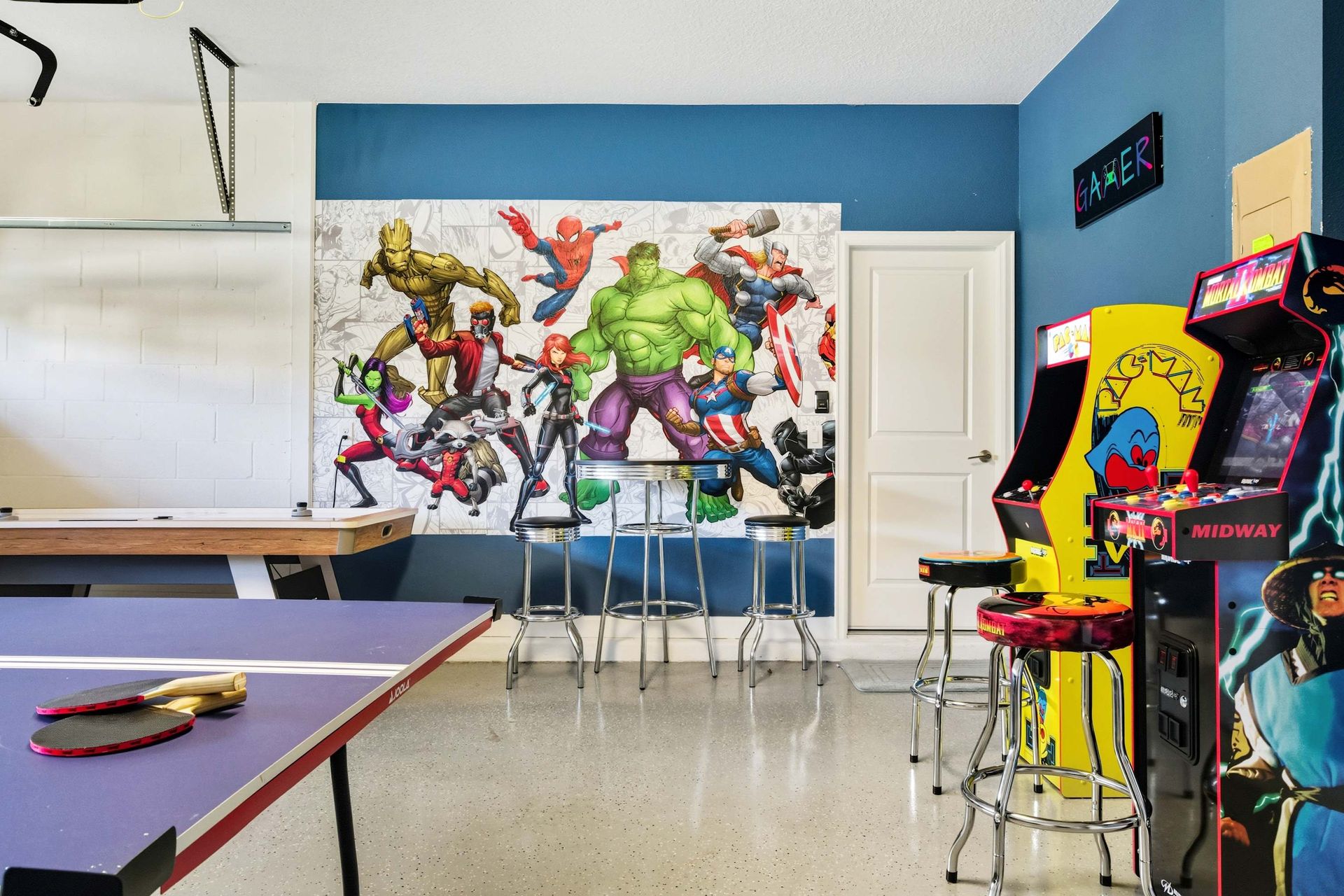 Game room heroes: pool, ping pong, arcade classics, and Marvel art.