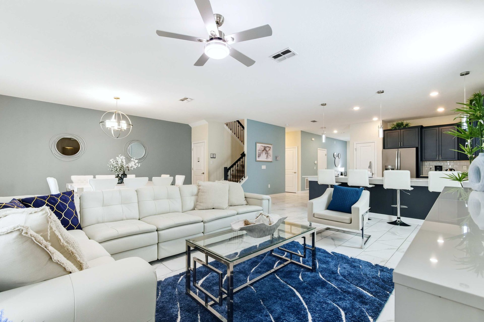 Modern lounge, stylish lighting, and soft blue walls.