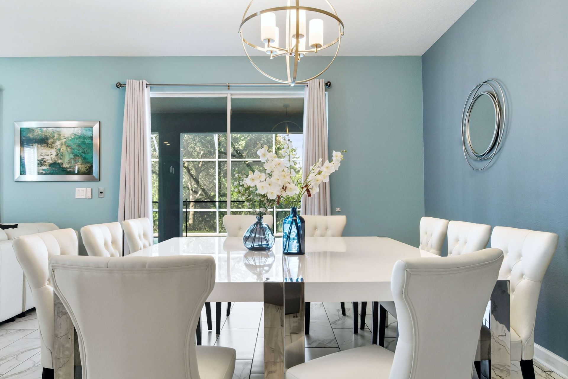 Elegant dining for eight with pool views and a serene blue palette.