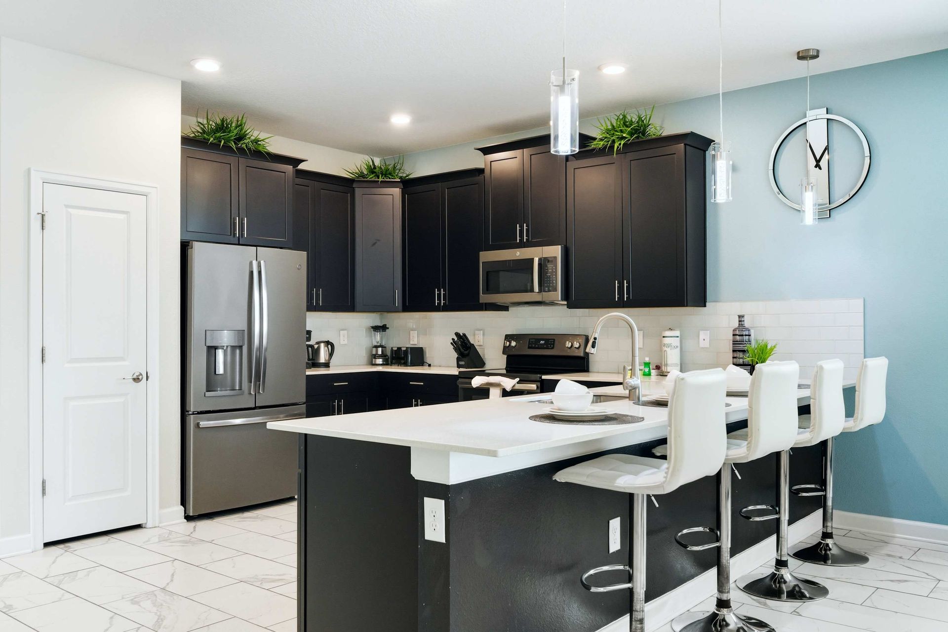 Sleek black cabinets contrast with a bright white island for four.
